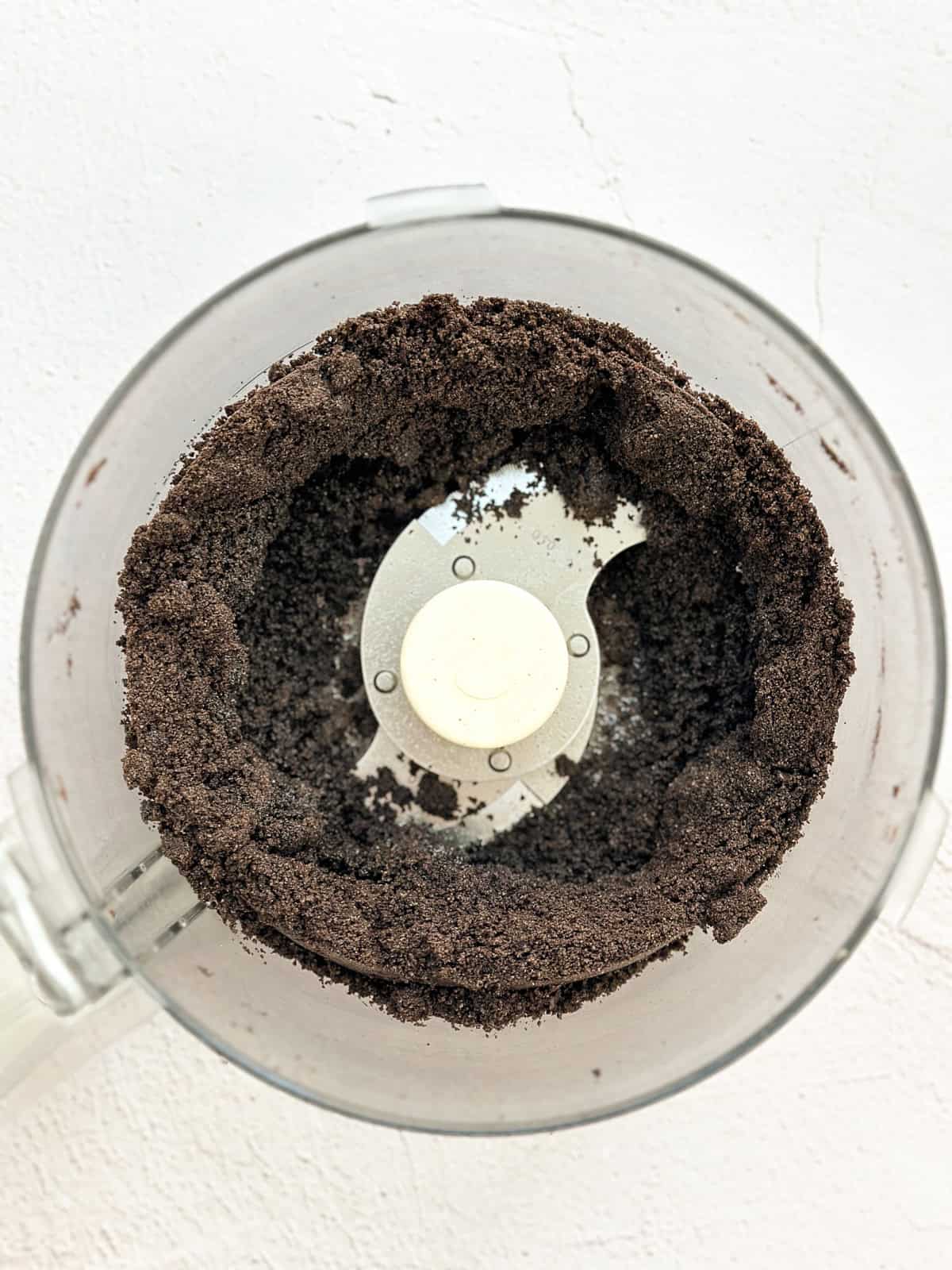 oreos and butter mixed in a food processor.