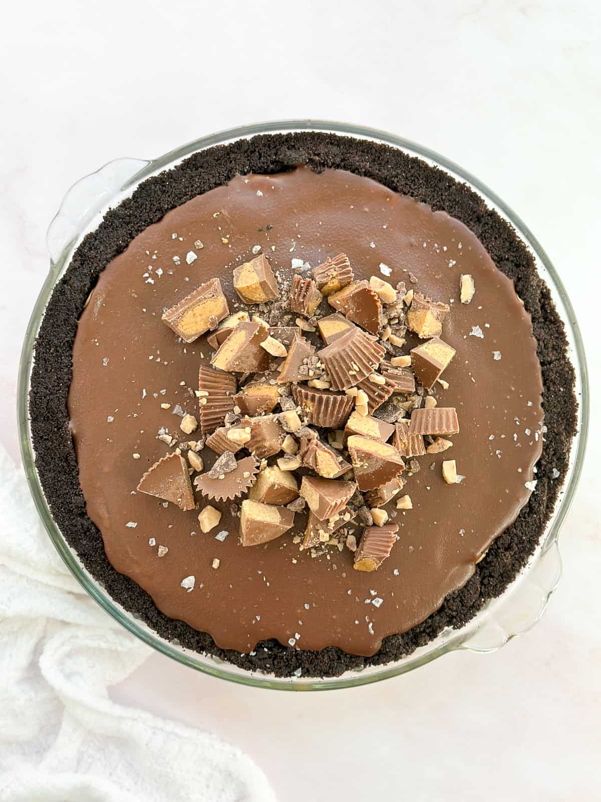 the peanut butter pie with chocolate ganache topped with extra peanut butter cups, toffee bits and salt.