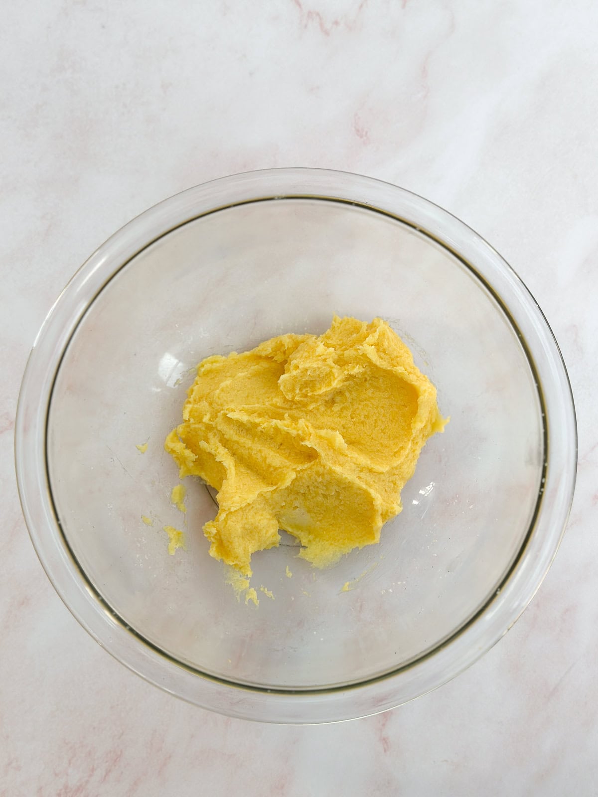 adding in the yolk and lemon juice.