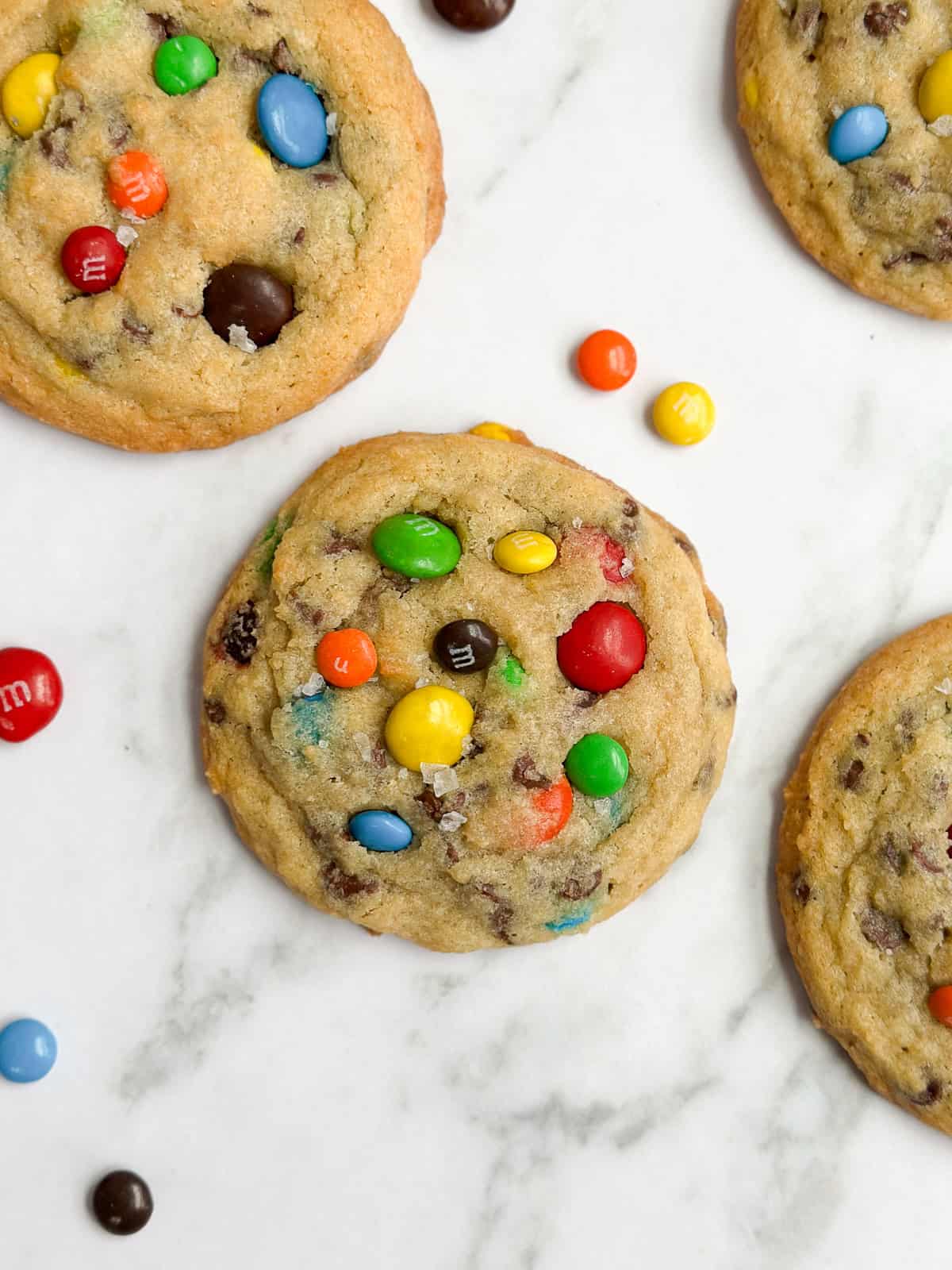 a closeup of a m&m chocolate chip cookie after baking.