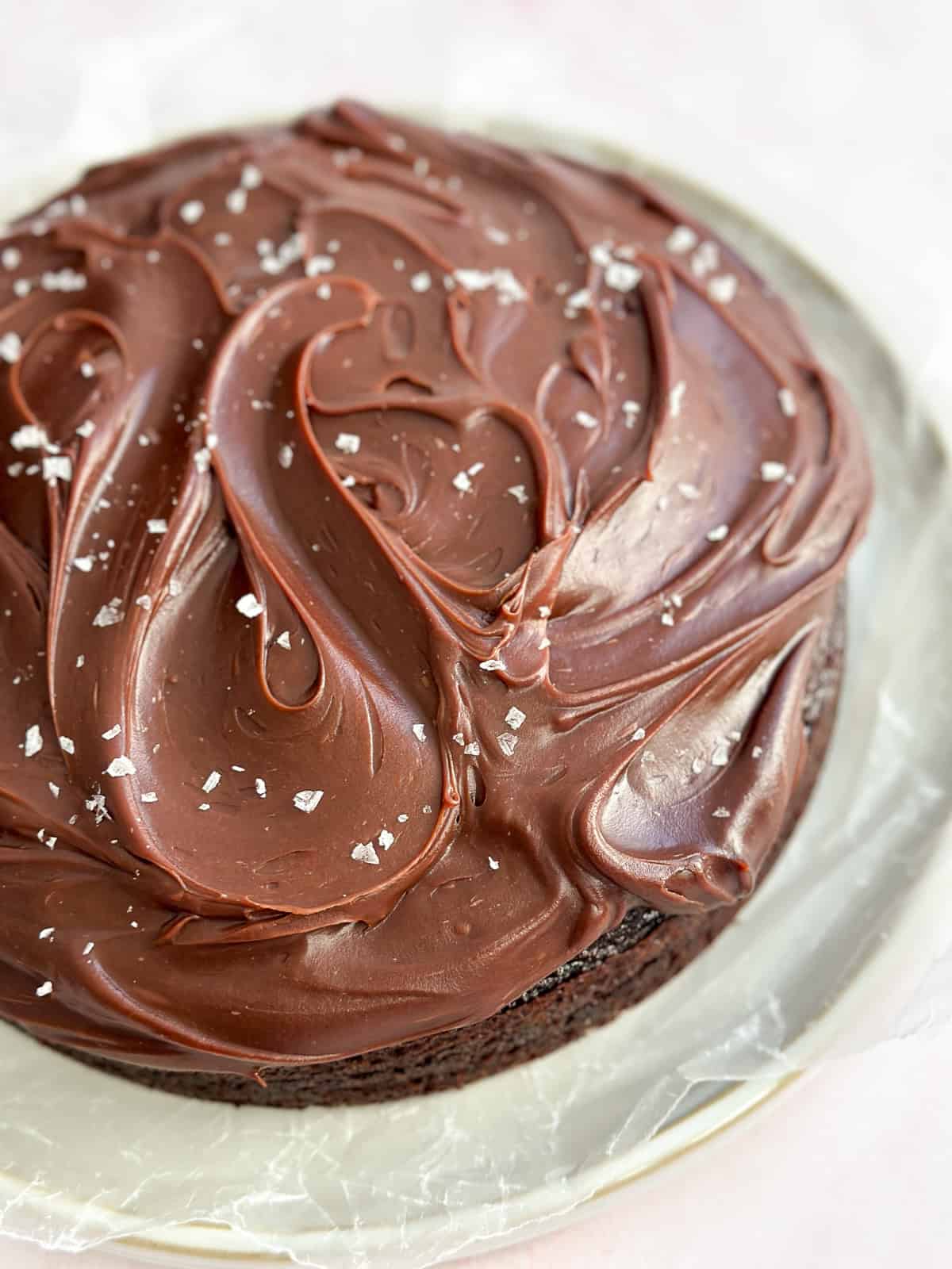 a close up of the chocolate ganache frosting on top of the cake.