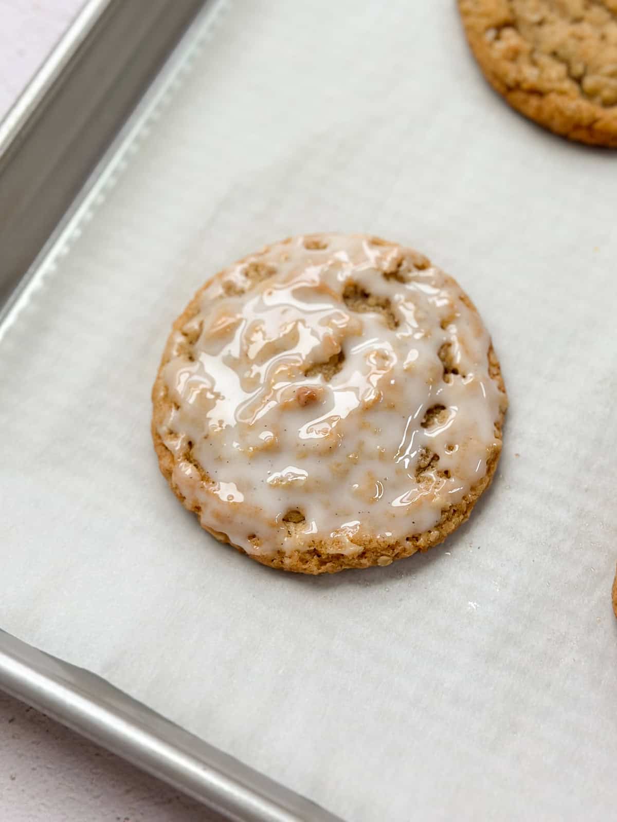 a single small batch oatmeal cookie on a baking sheet.