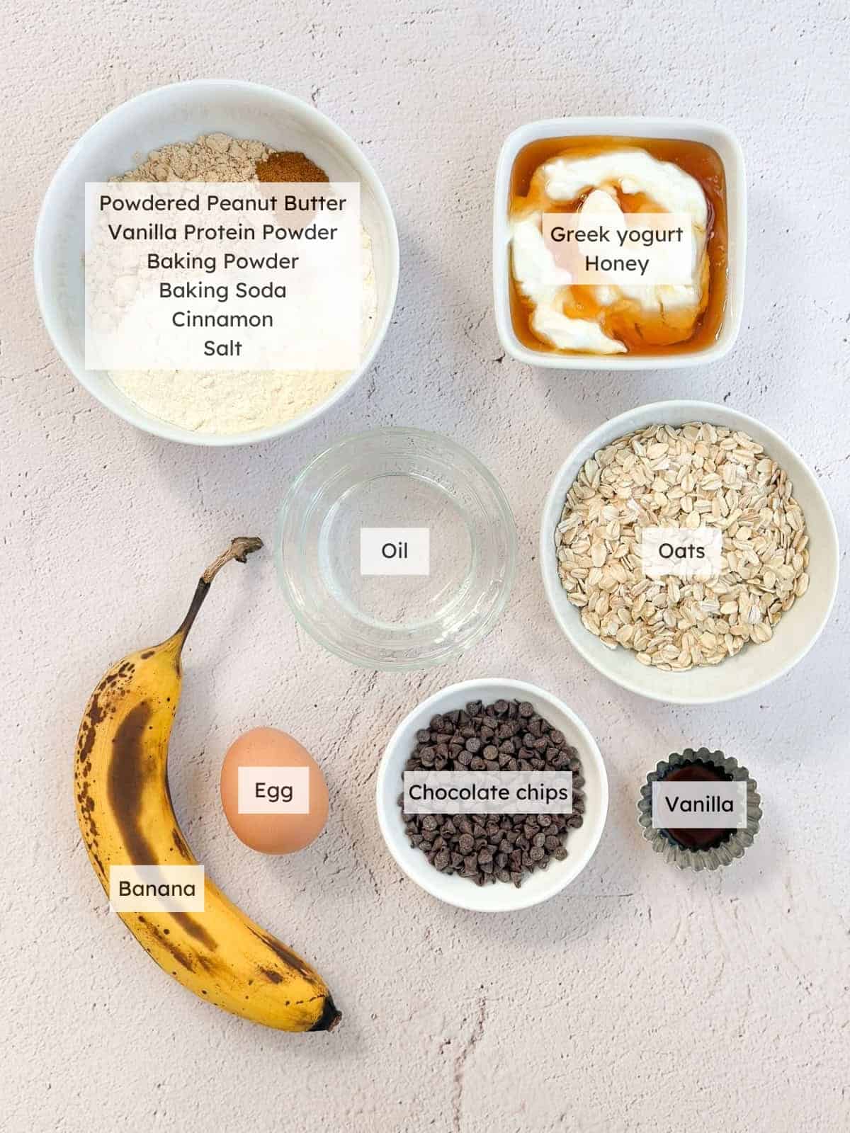 All of the ingredients needed to make banana chocolate chip protein muffins.