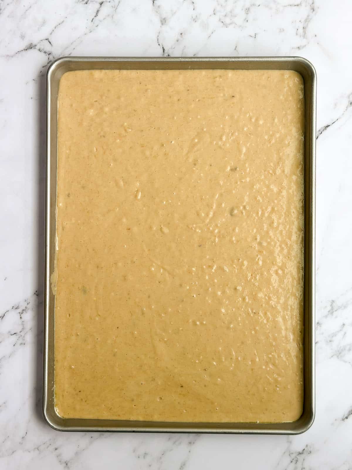banana batter in the sheet cake pan before baking.