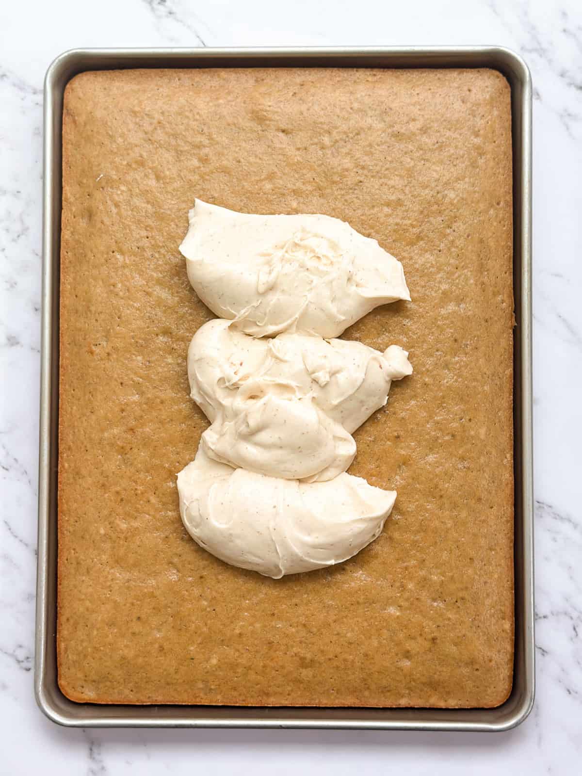 the banana sheet cake with some dollops of brown butter frosting on top.