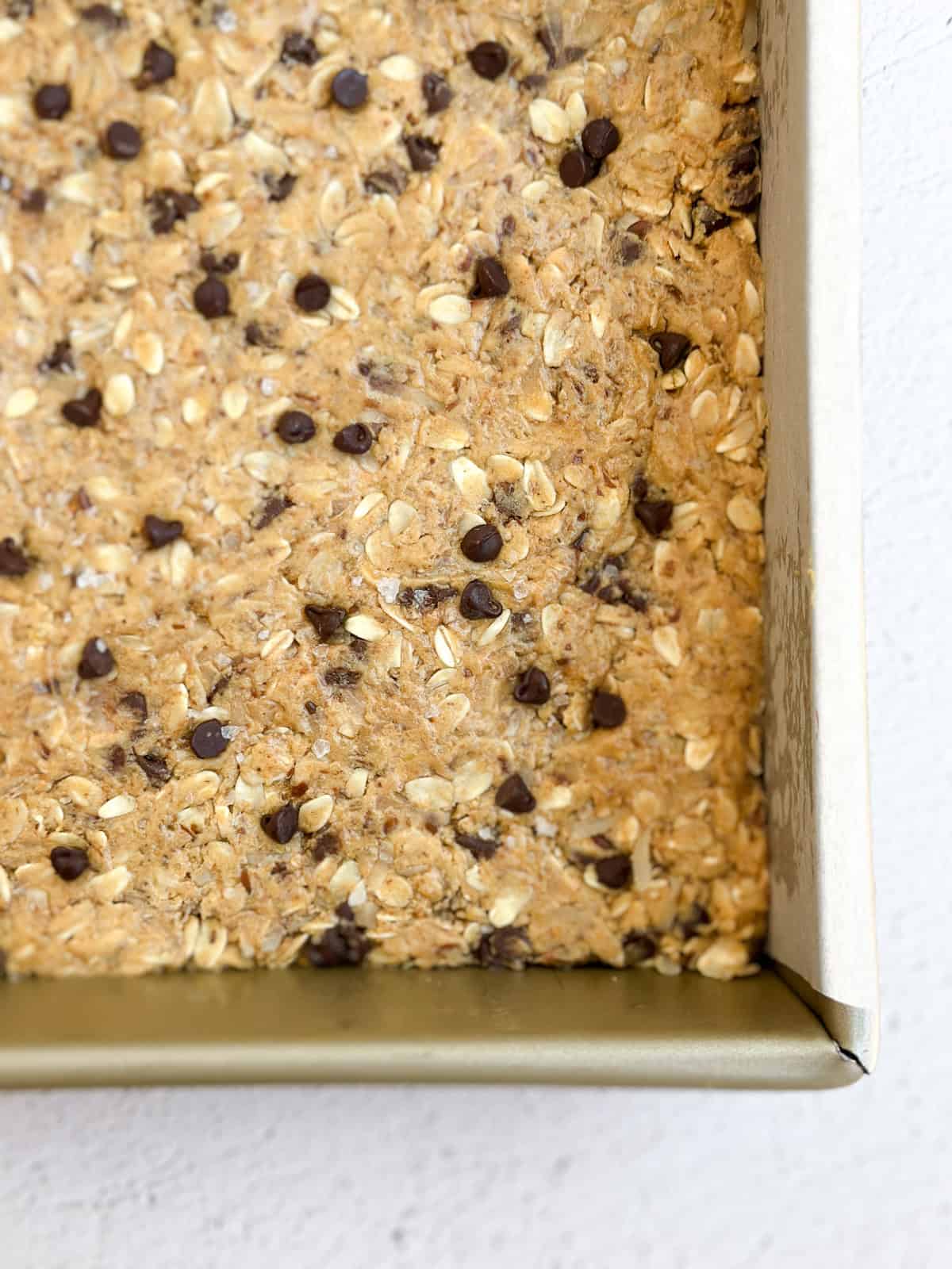 a close up of the homemade peanut butter protein bars in the pan before cutting.