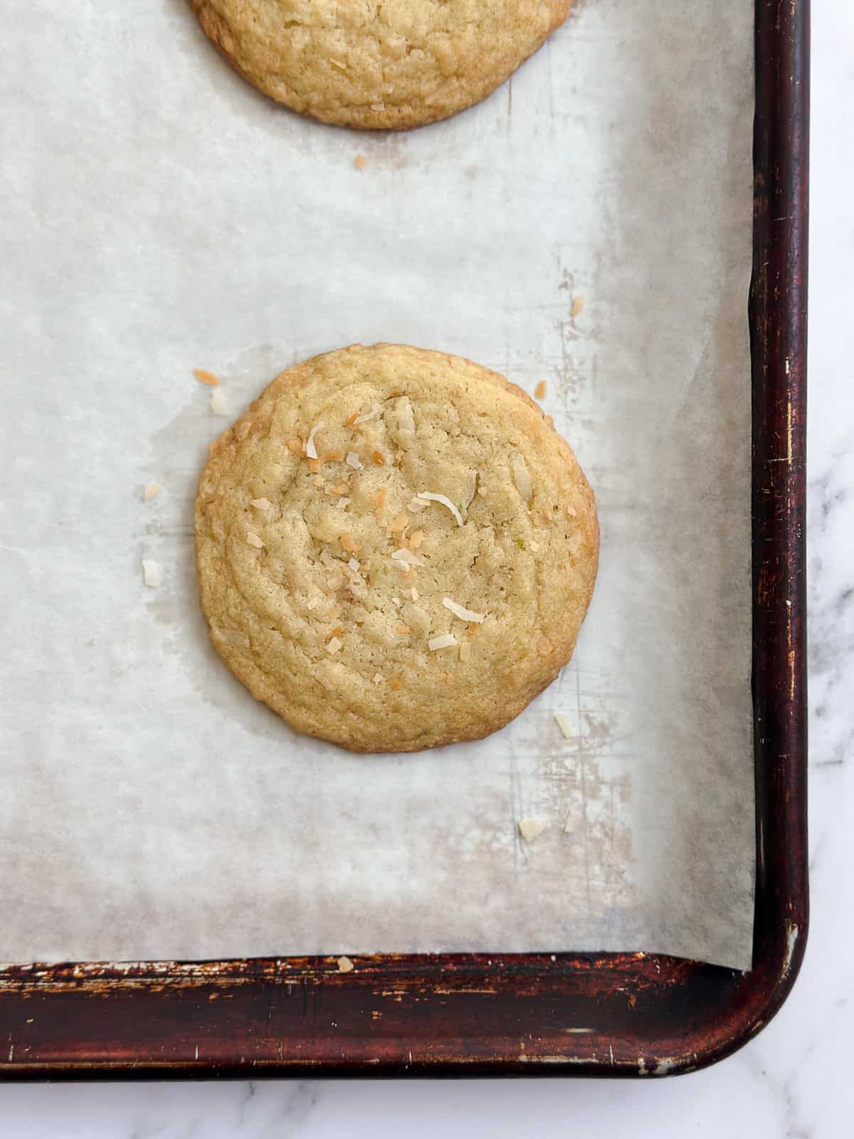 freshly bakes lime coconut cookies on the baking sheet.