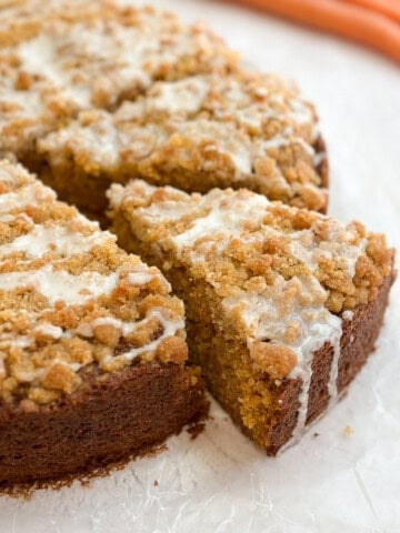 a piece of carrot cake coffee cake coming out from the whole cake.