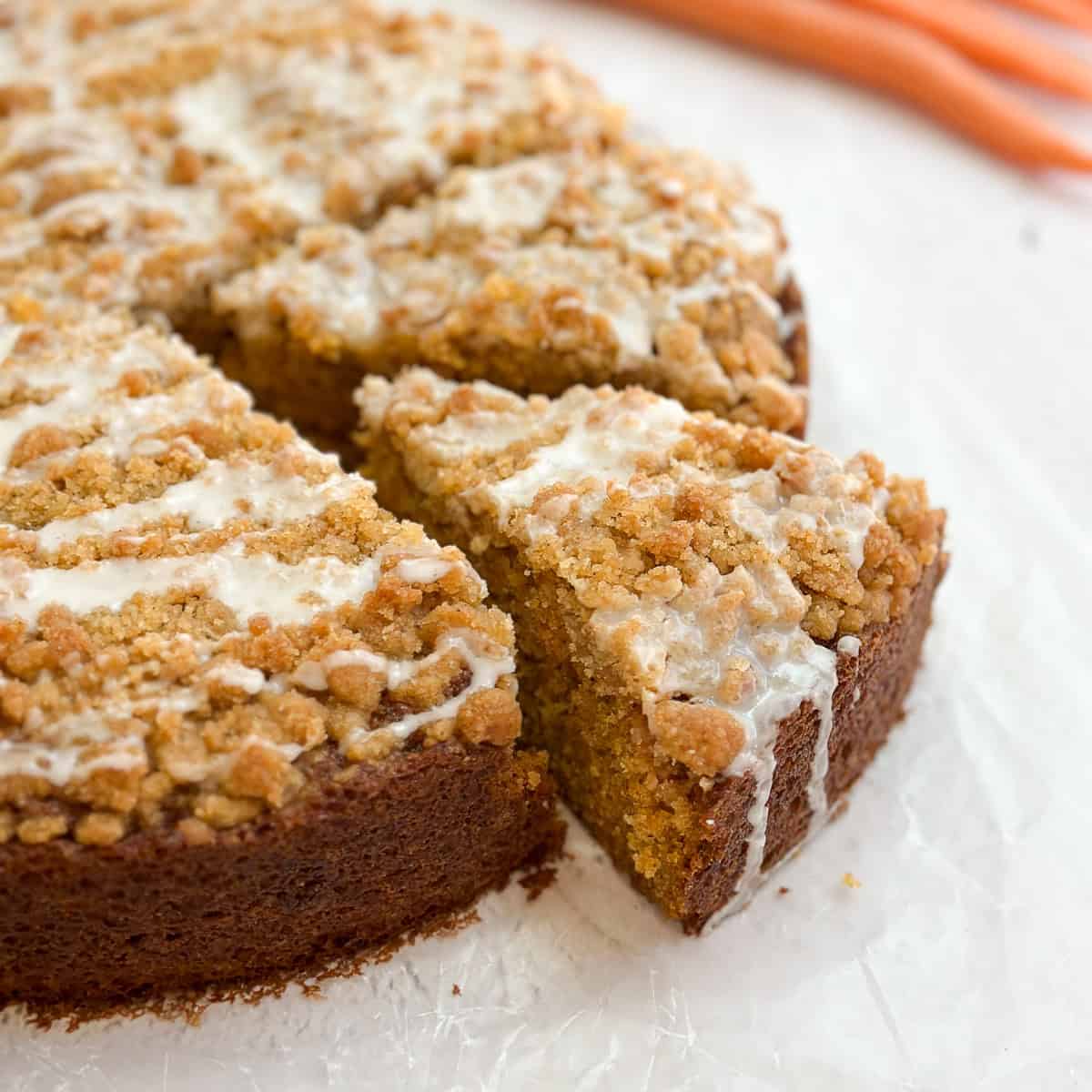 a piece of carrot cake coffee cake coming out from the whole cake.