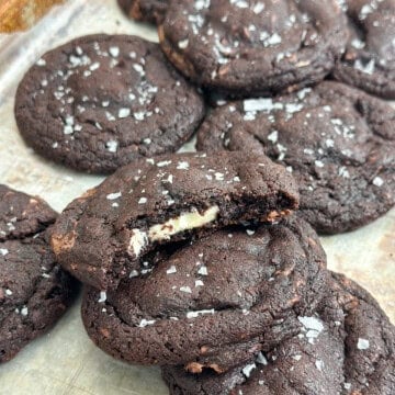 a bite out of a triple chocolate cookies so you can see the white chocolate center.
