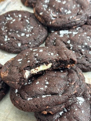 a bite out of a triple chocolate cookies so you can see the white chocolate center.