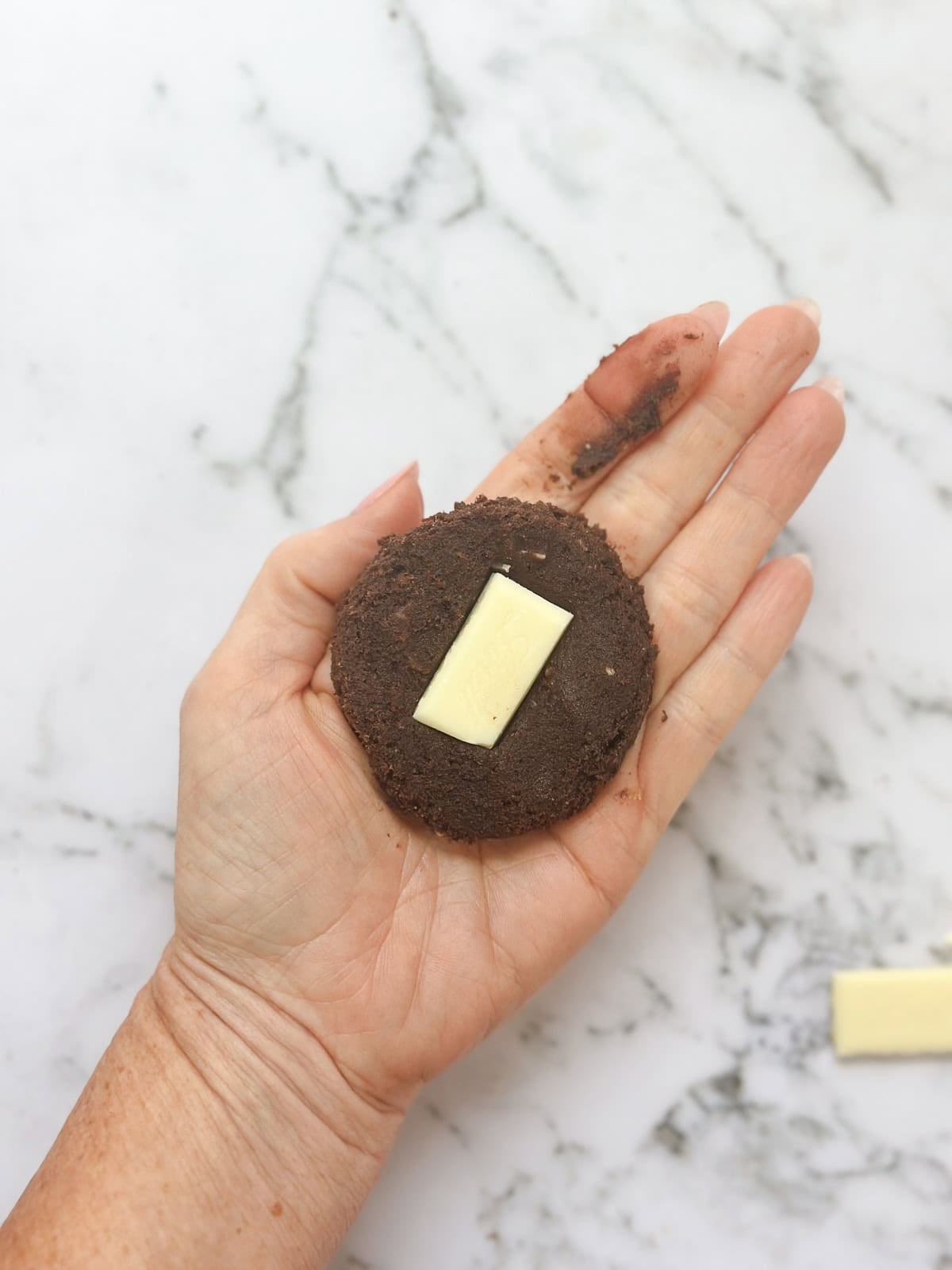 adding the white chocolate to the middle of the dough.