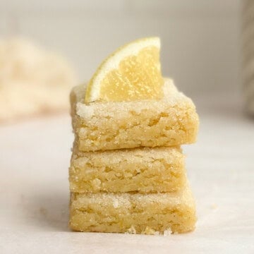 3 lemon sugar cookie bars stacked on top of each other.