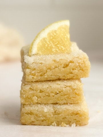 3 lemon sugar cookie bars stacked on top of each other.