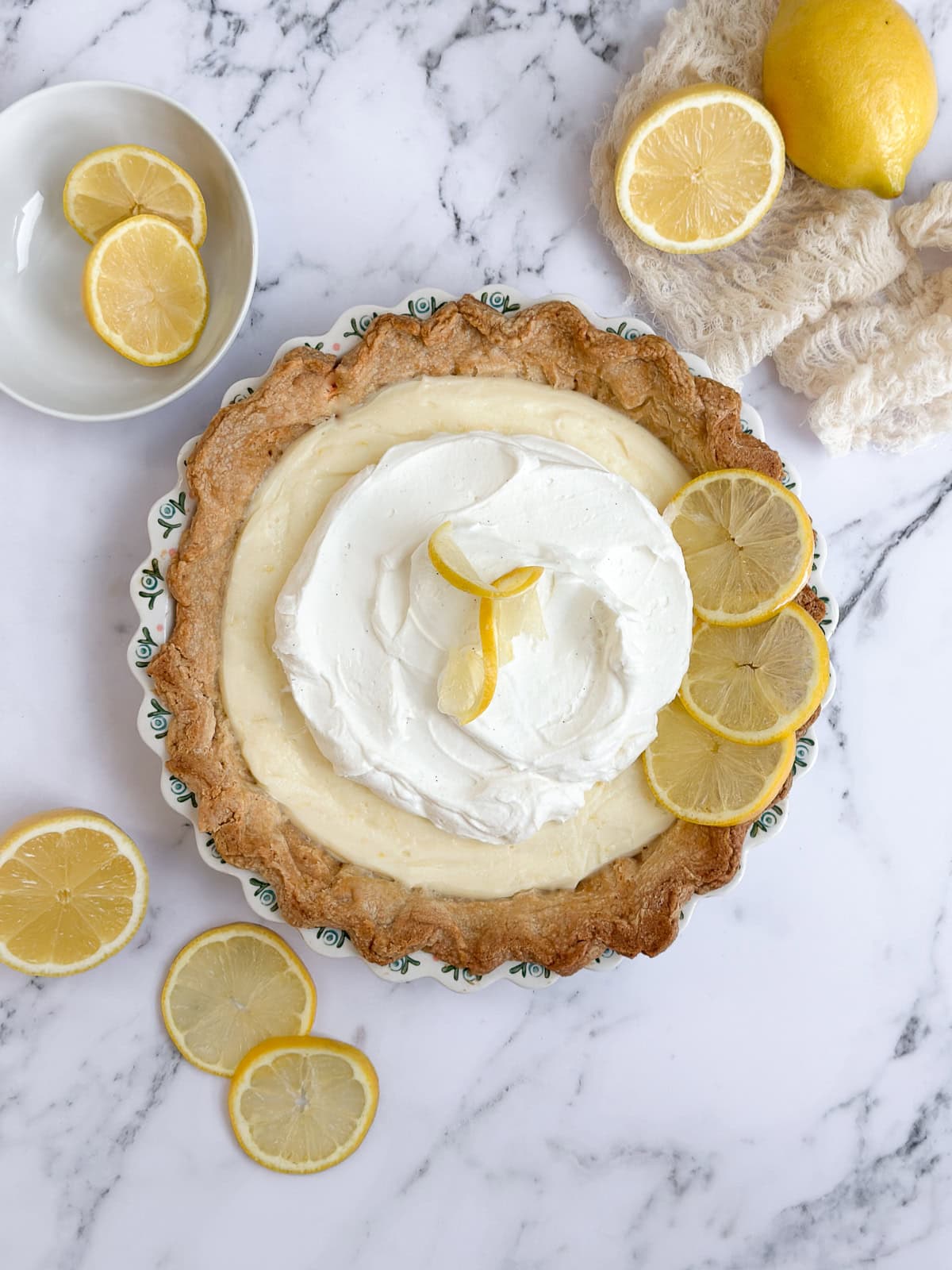 the whole lemon sour cream pie with lemon slices all around.