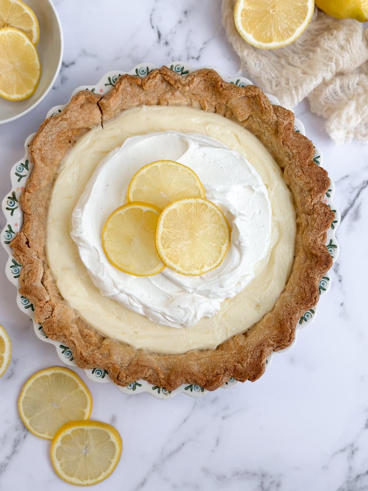 the lemon sour cream pie topped with whipped cream.