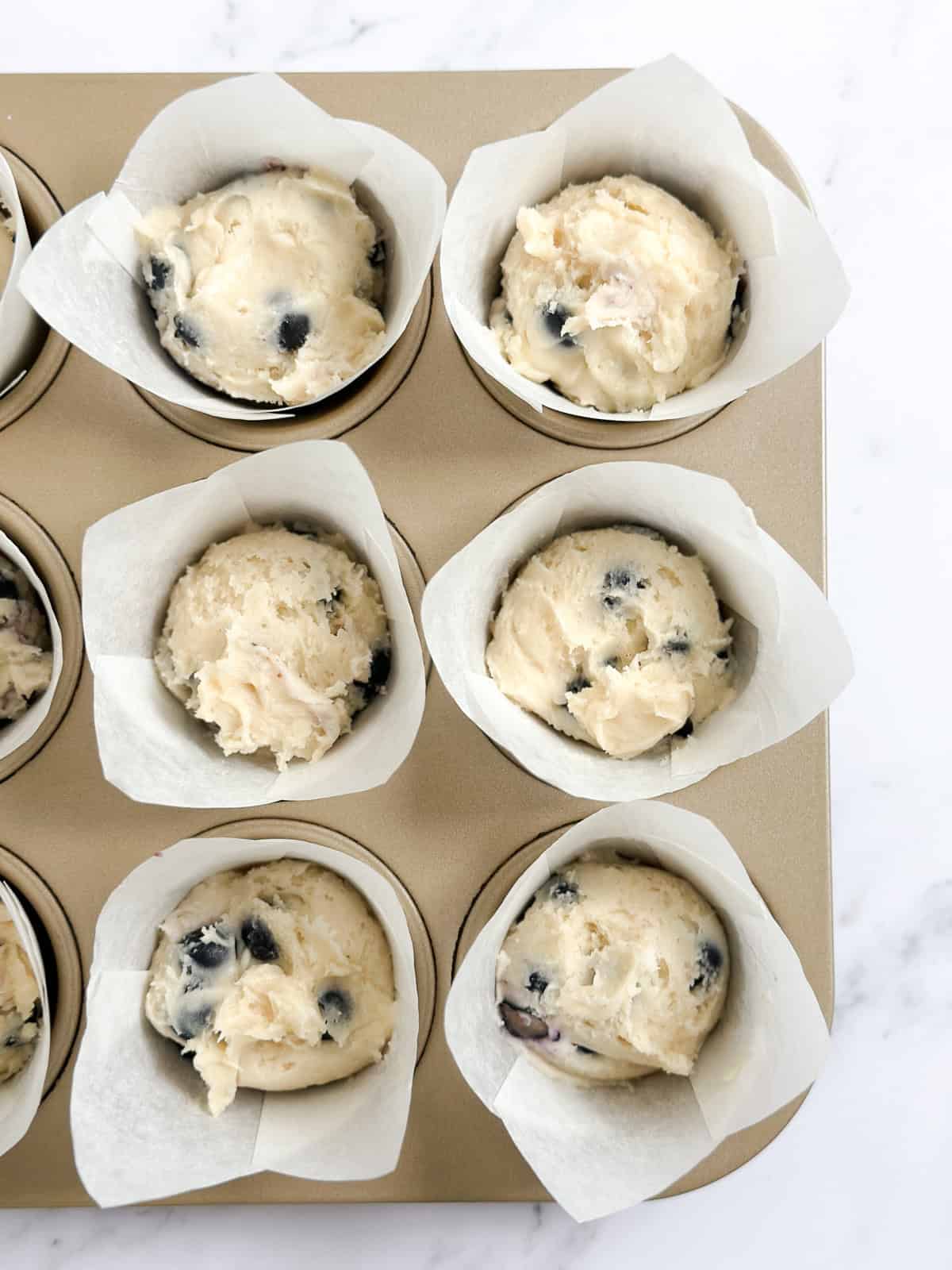 muffin batter added to the muffin cups.