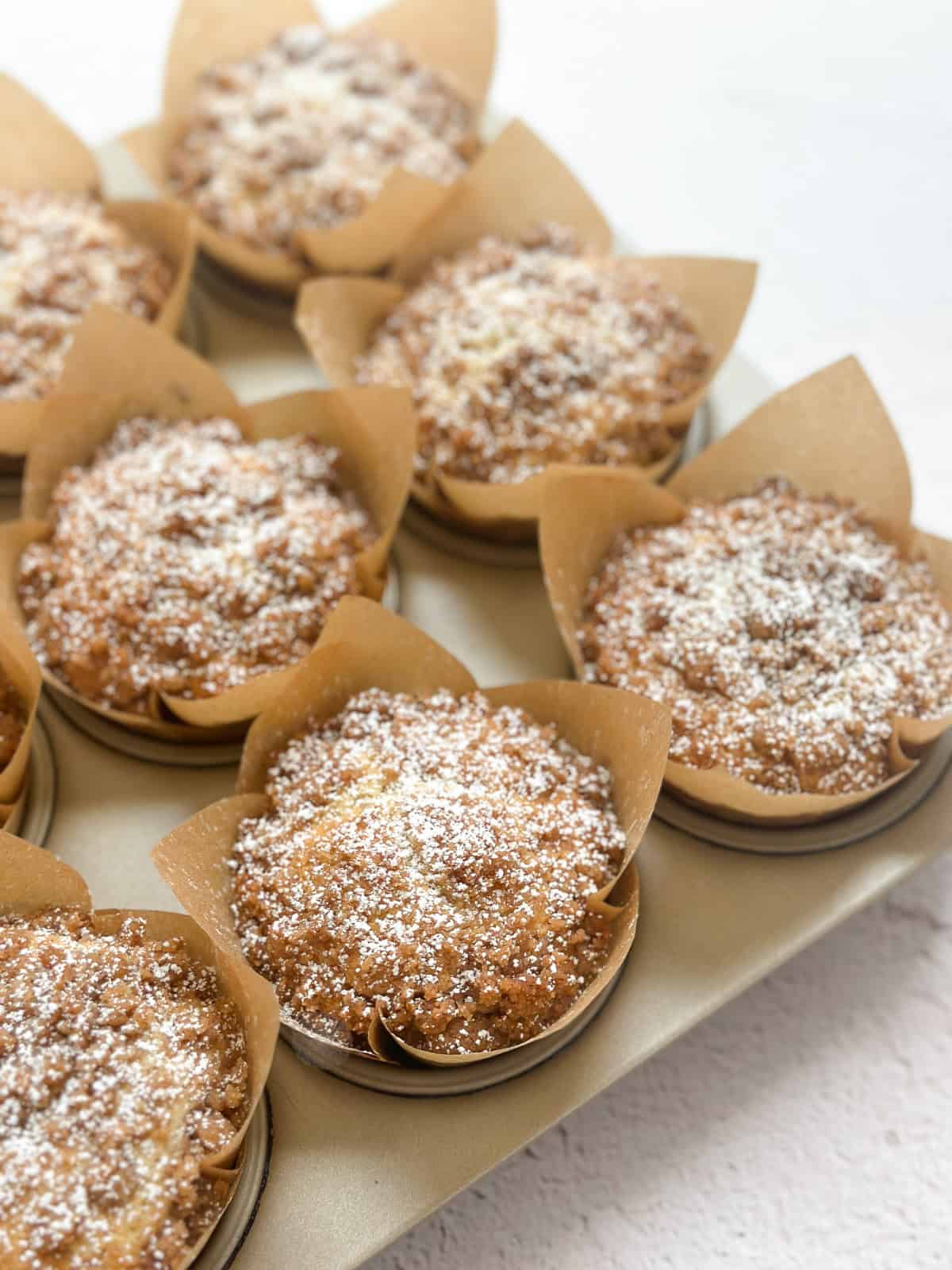 muffins topped with powdered sugar.