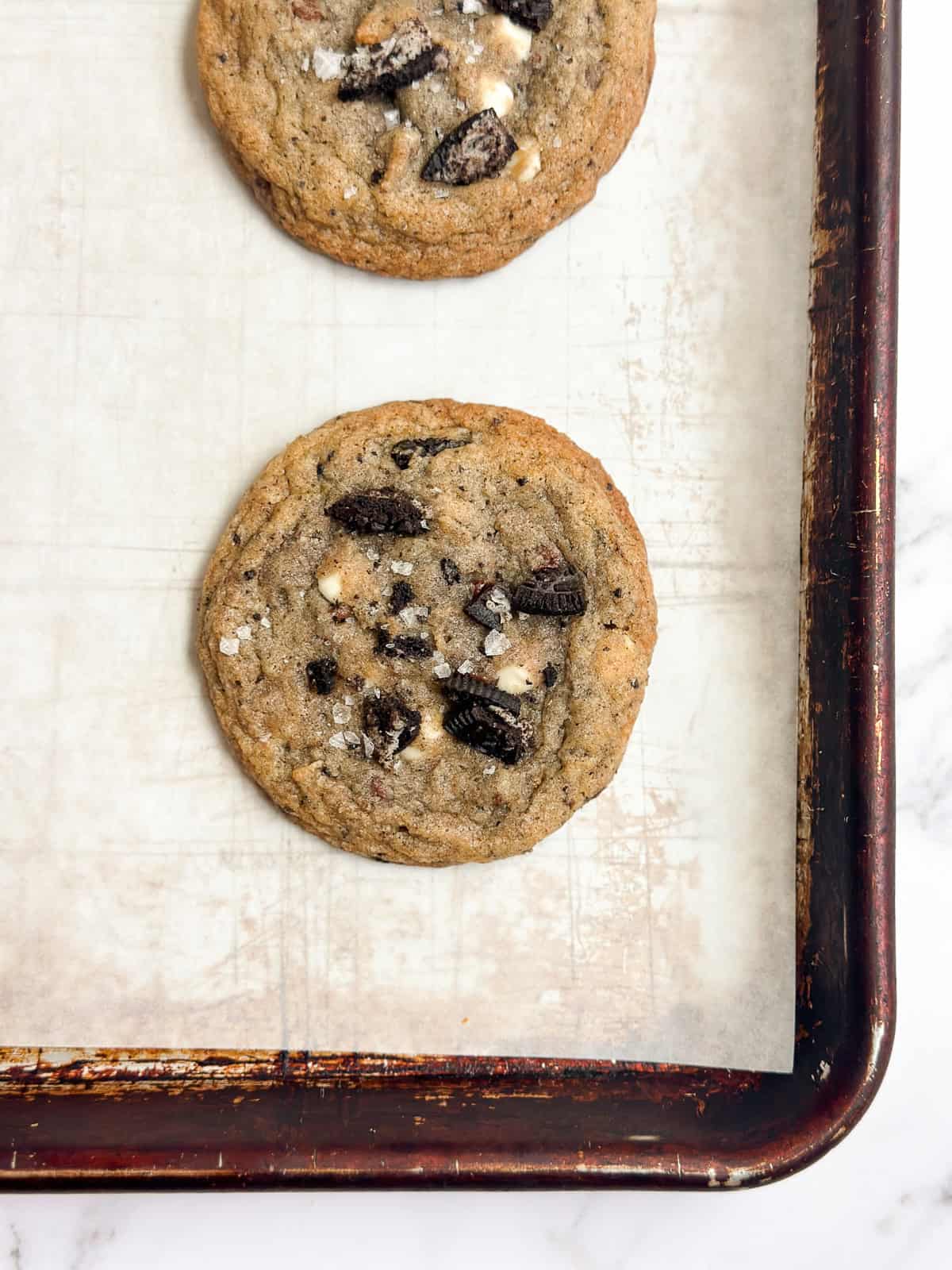 a close up of a cookies and cream cookie right after baking.