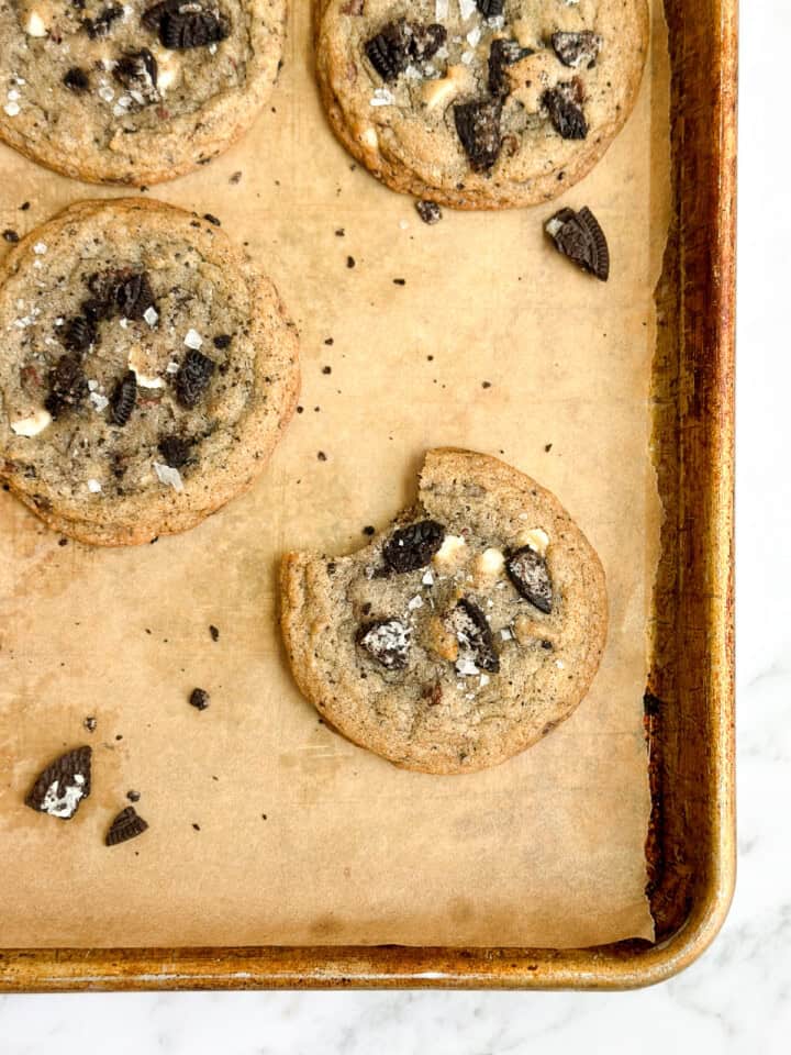 a cookies and cream cookie with a bite missing.