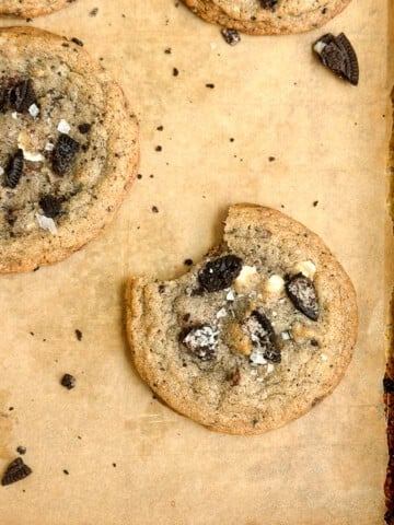 a cookies and cream cookie with a bite missing.