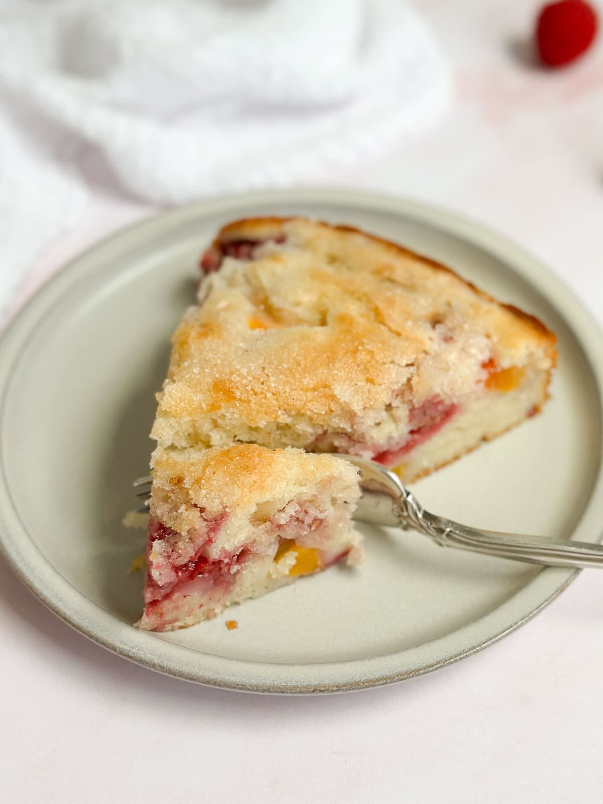 a piece of the cake on a plate with a fork cut into it.