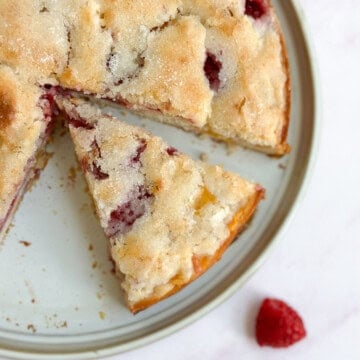 a slice of the raspberry peach cake separate from the rest of the cake.