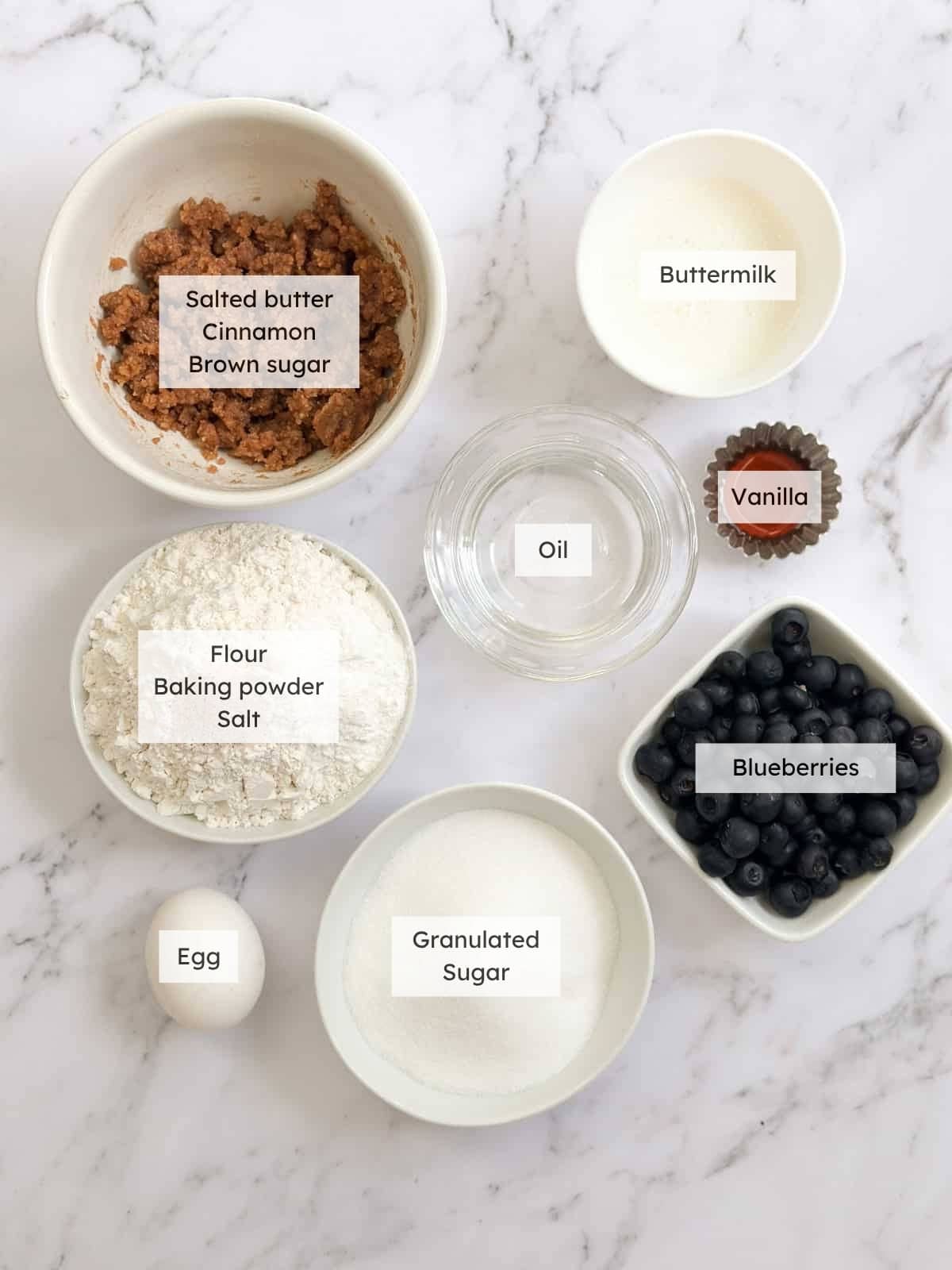 All of the ingredients needed to make blueberry coffee cake muffins.