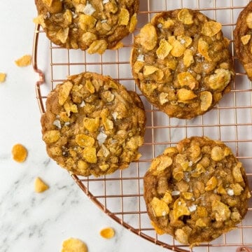 salted oatmeal cornflake cookies on a cooling rack.