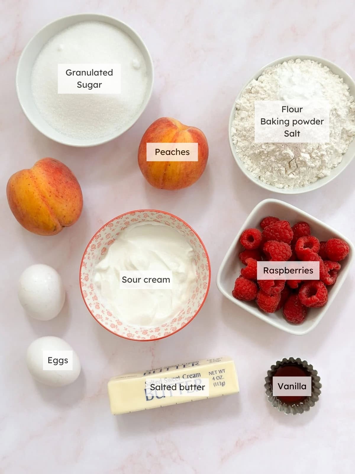 All of the ingredients needed to make peach raspberry cake.