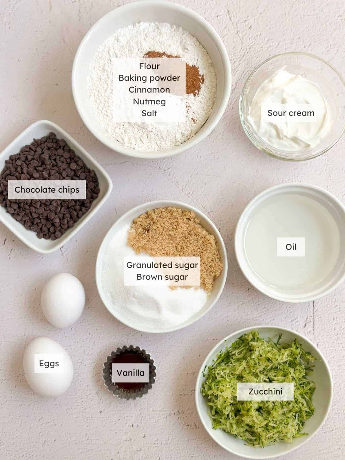 All of the ingredients needed to make chocolate chip zucchini cake.
