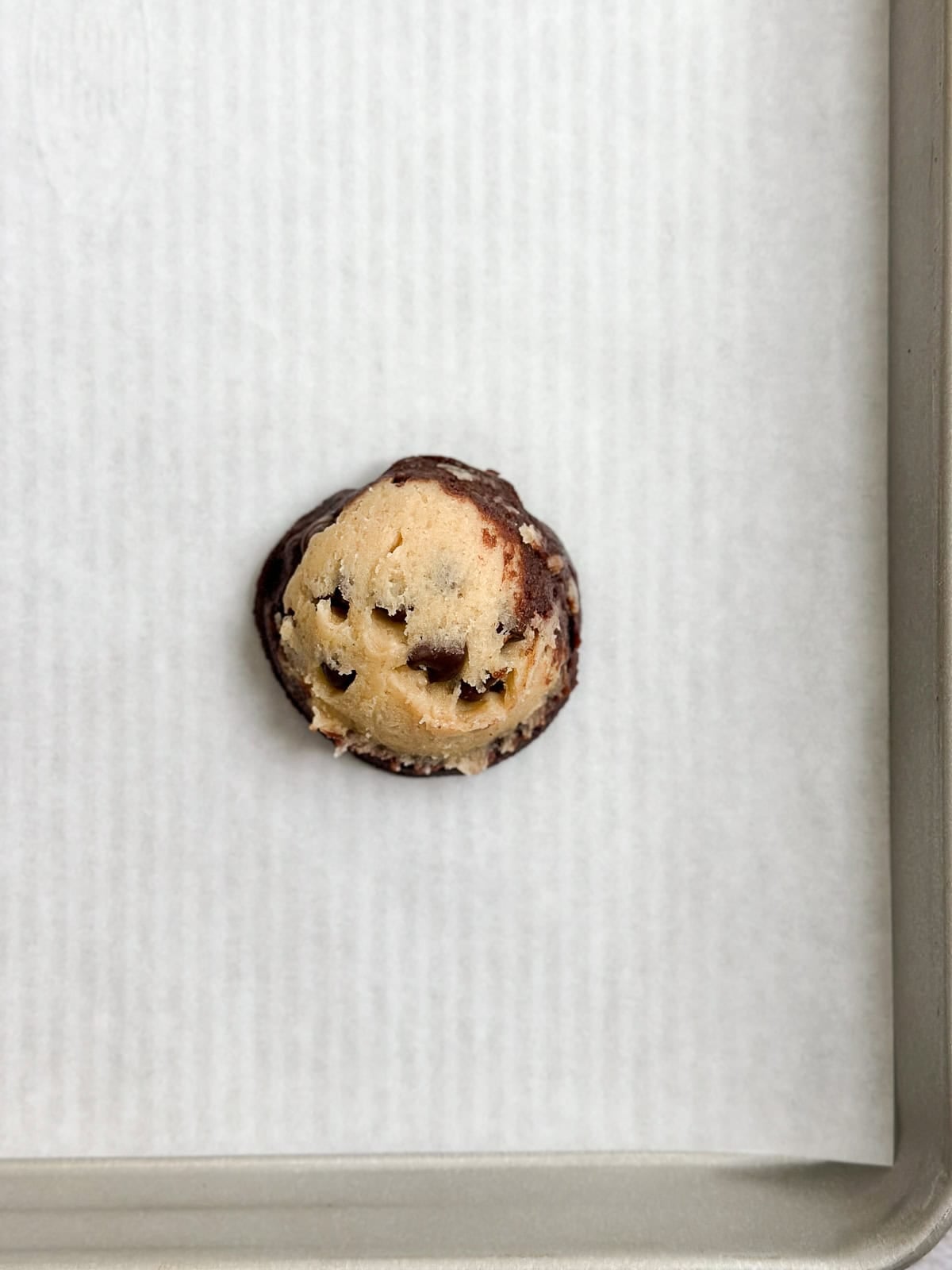 showing the cookie dough ball before baking.