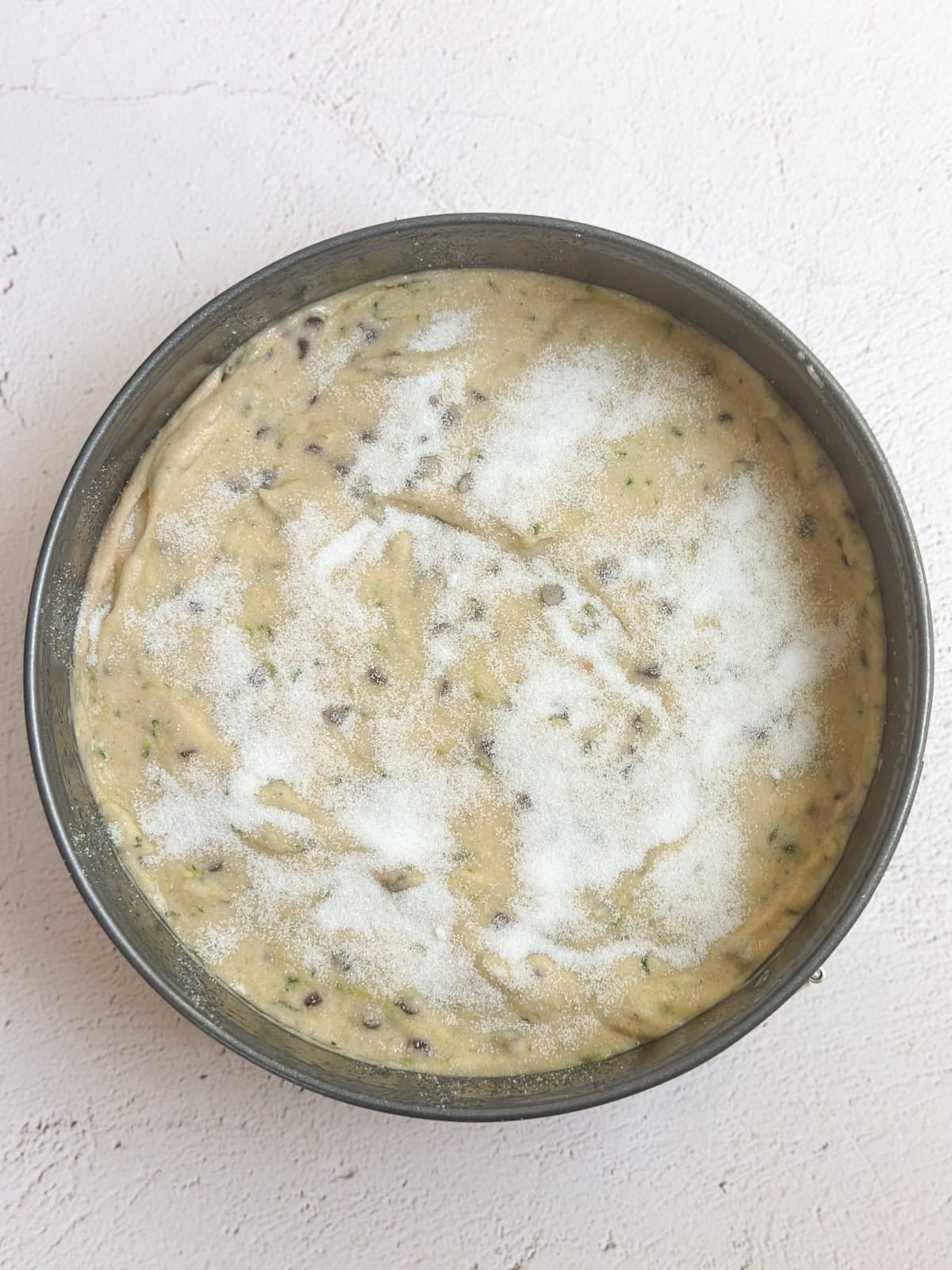 the cake in the pan with the sugar sprinkled on top right before baking.