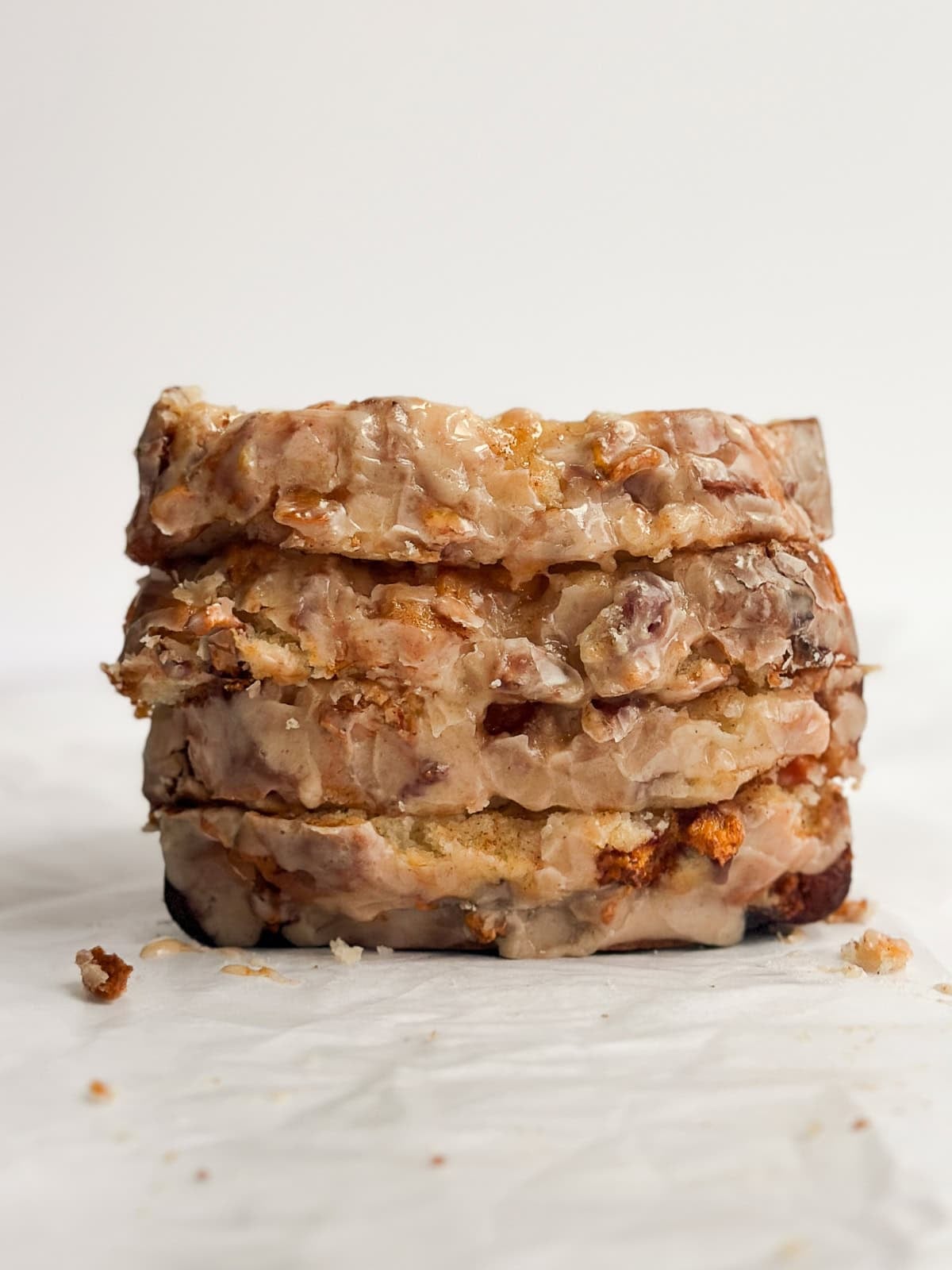 four slices of peach loaf cake stacked on top of each other.