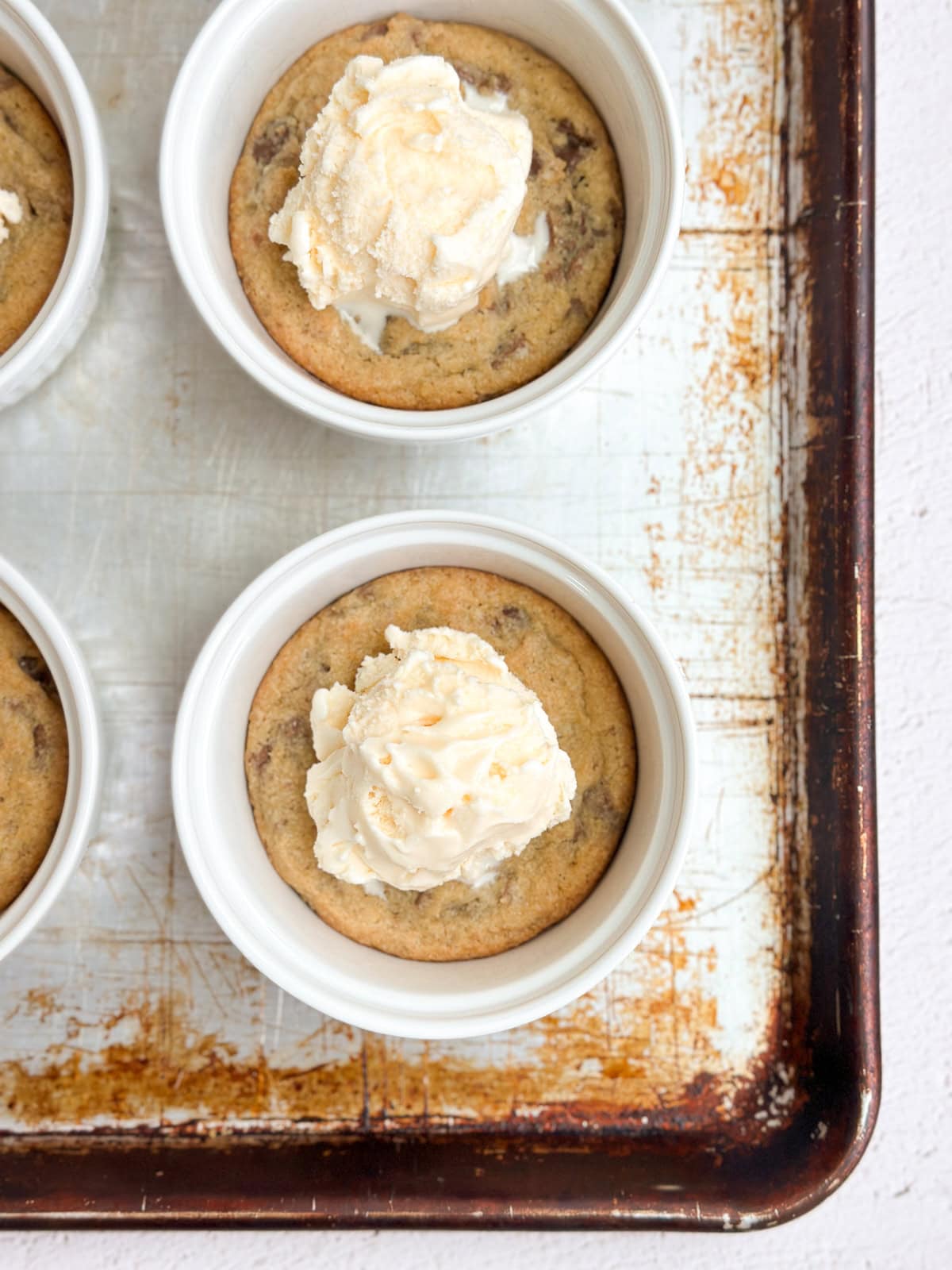 mini chocolate chip cookie sundaes on a baking sheet.