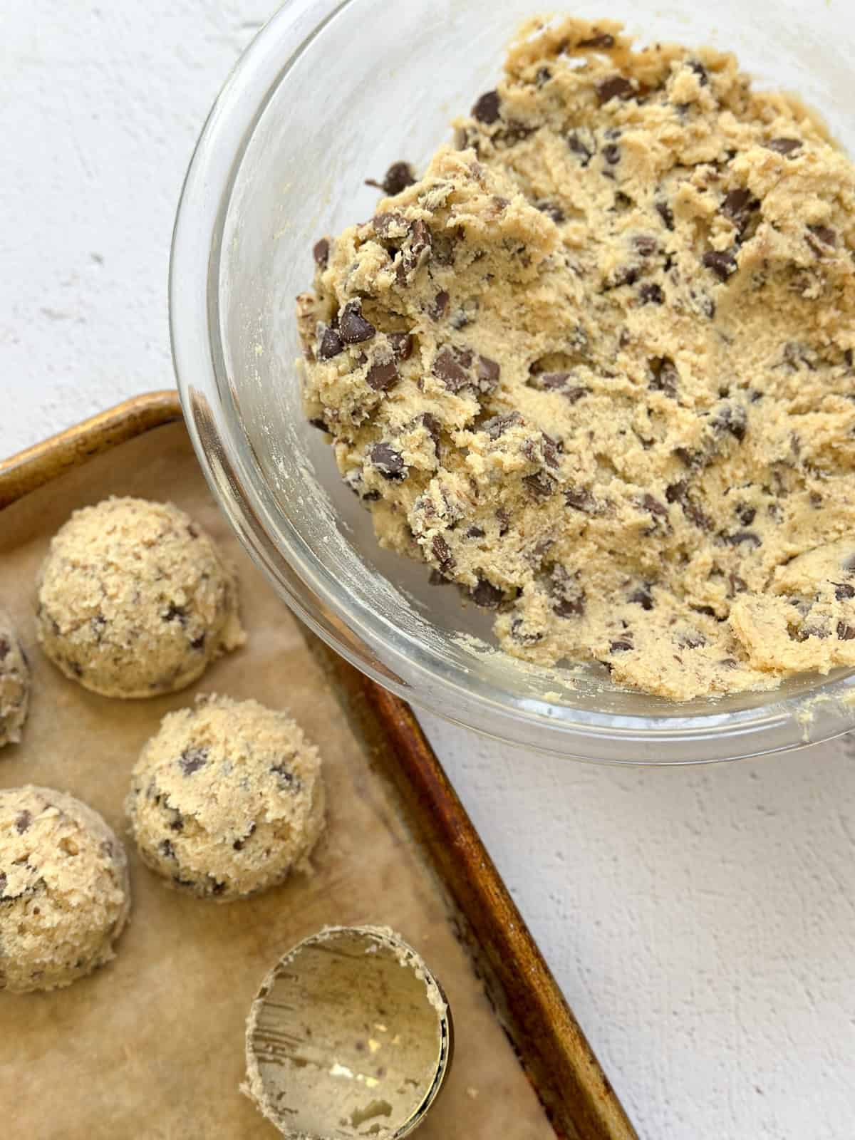 cookie dough being scooped into balls.