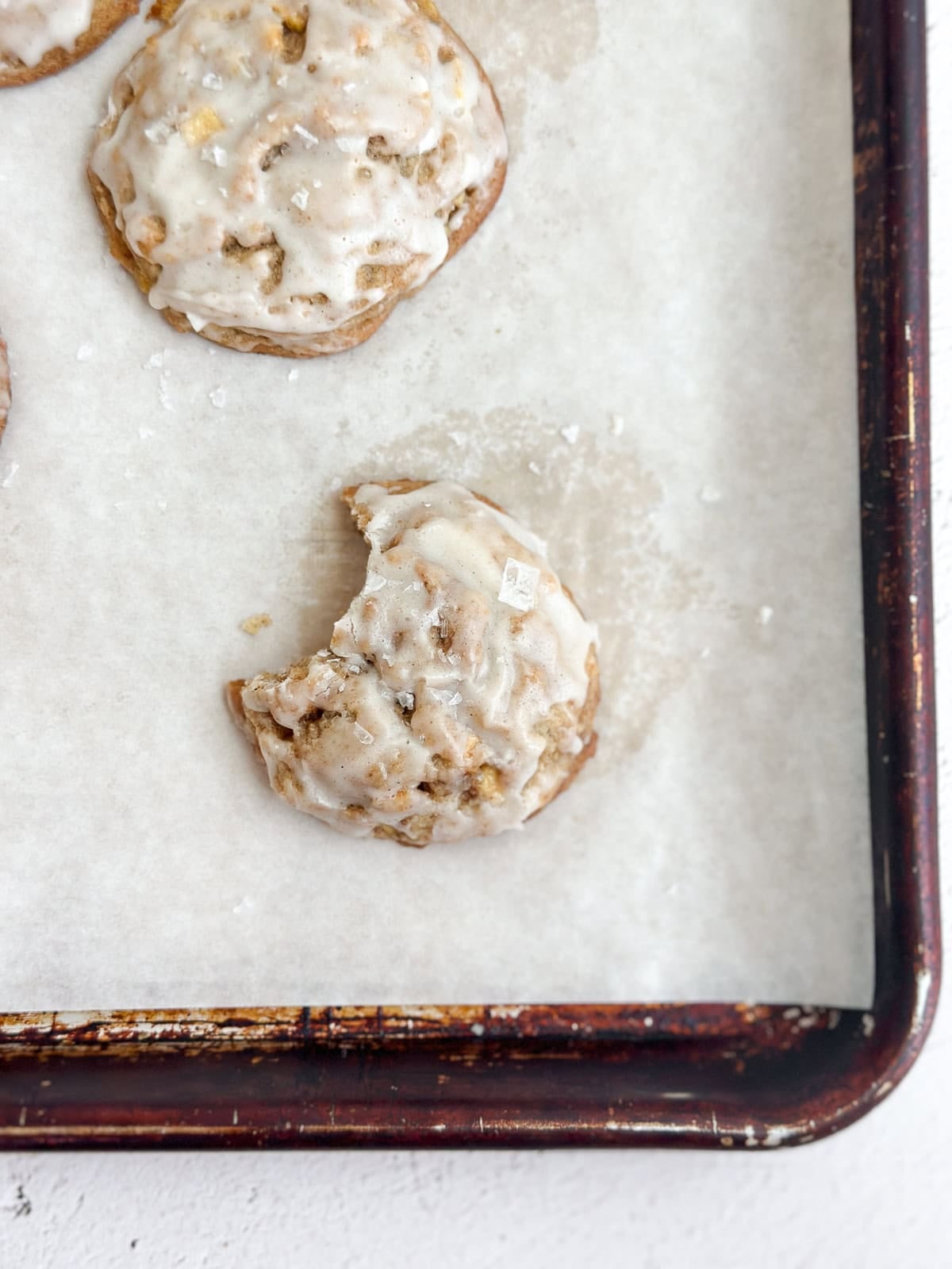 an apple cinnamon cookie with a big bite missing.