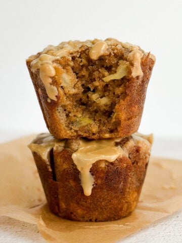 2 apple cinnamon oat muffins stacked on top of each other.