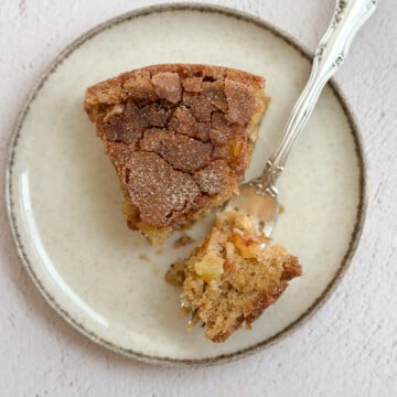 a single slice of this easy apple oatmeal cake on a plate with a bite on a fork.