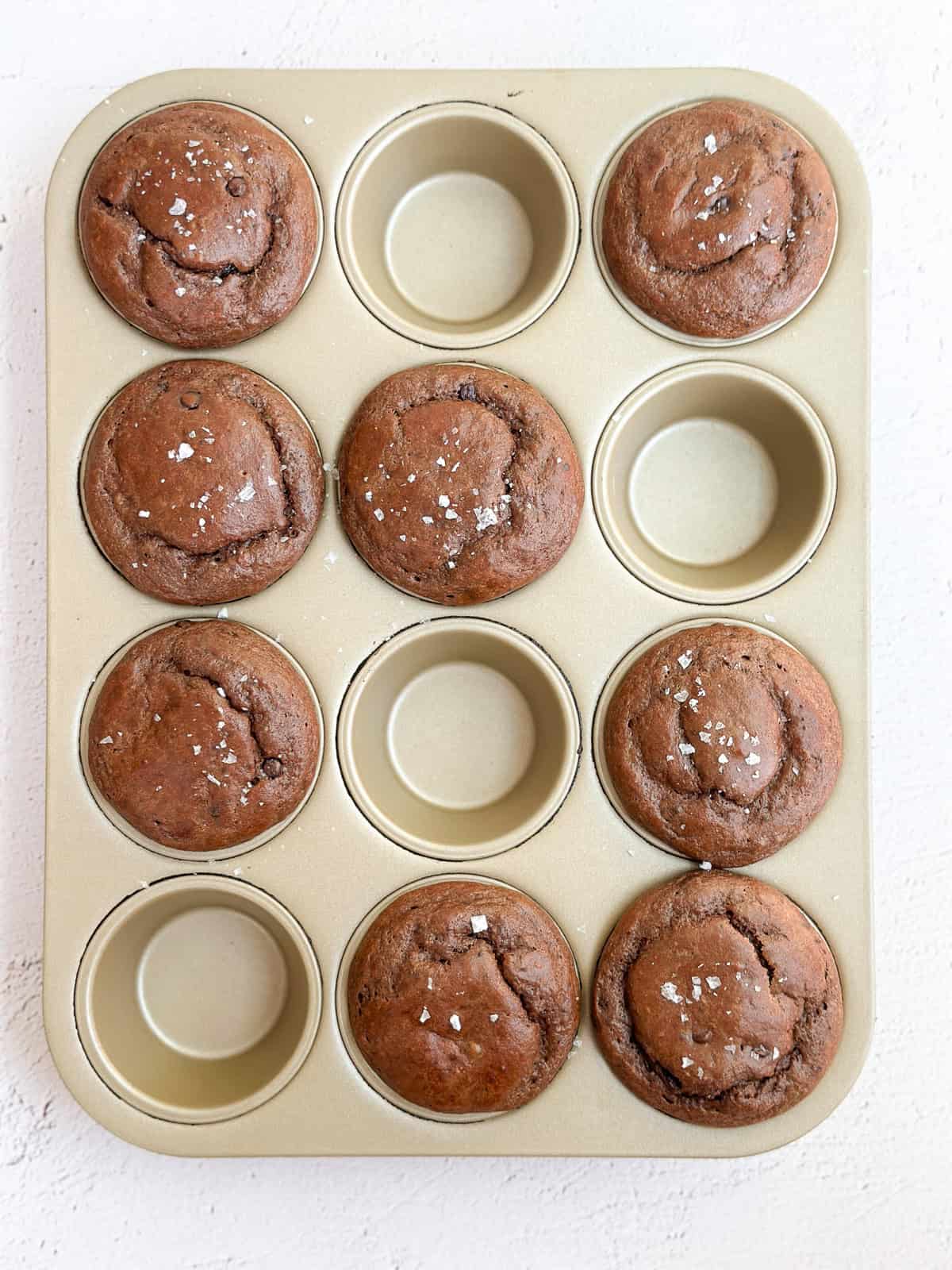 all of the chocolate protein muffins in a muffin tin right after baking.