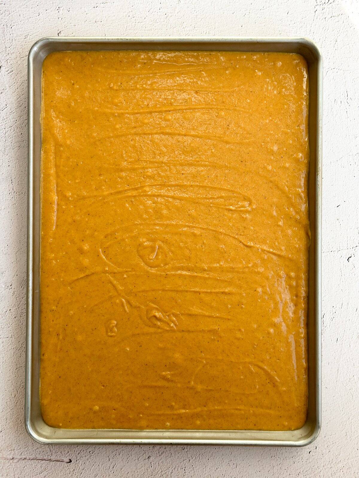 the batter added to the sheet pan before baking.