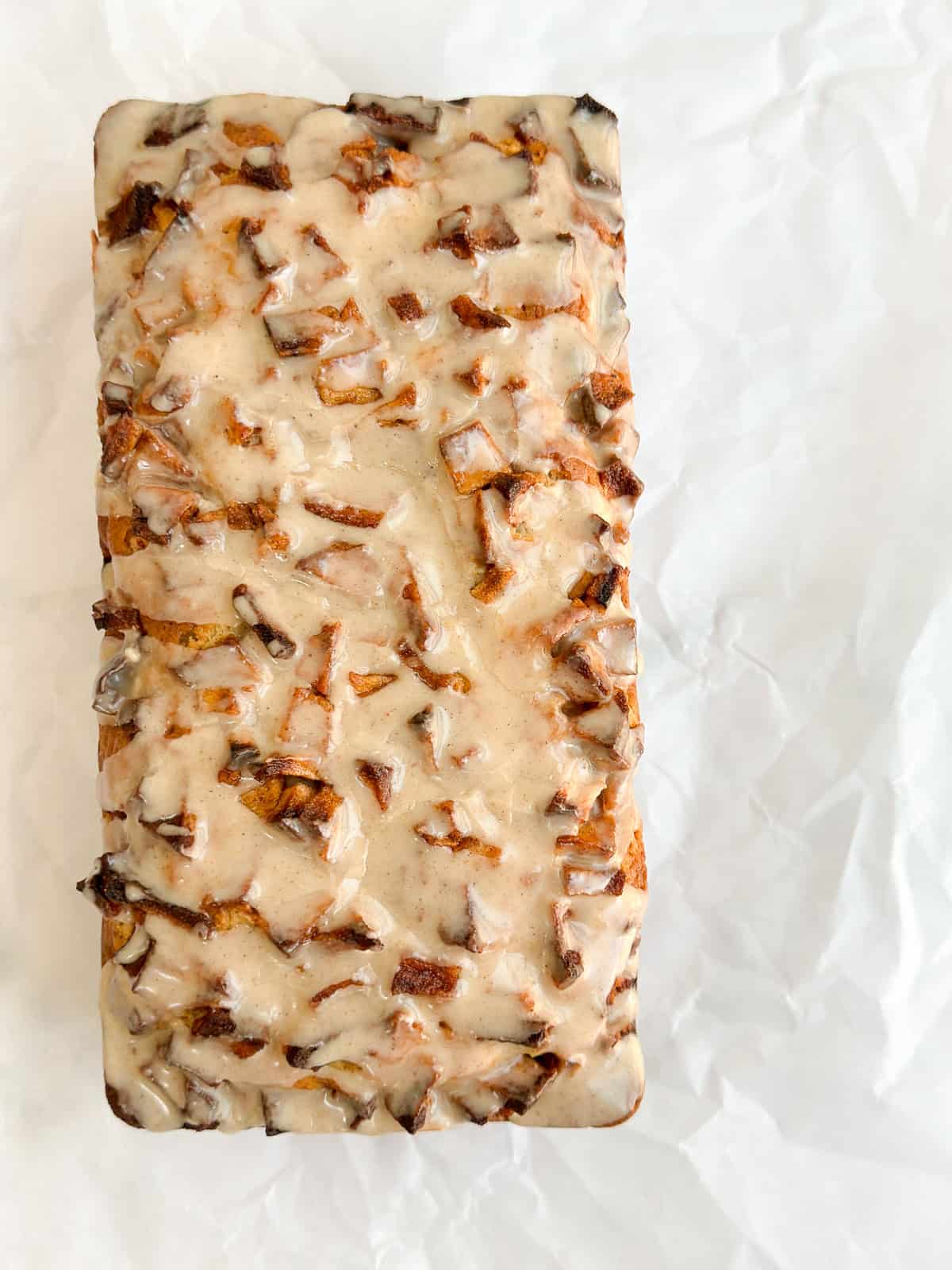 the apple fritter bread right after pouring the glaze on top.