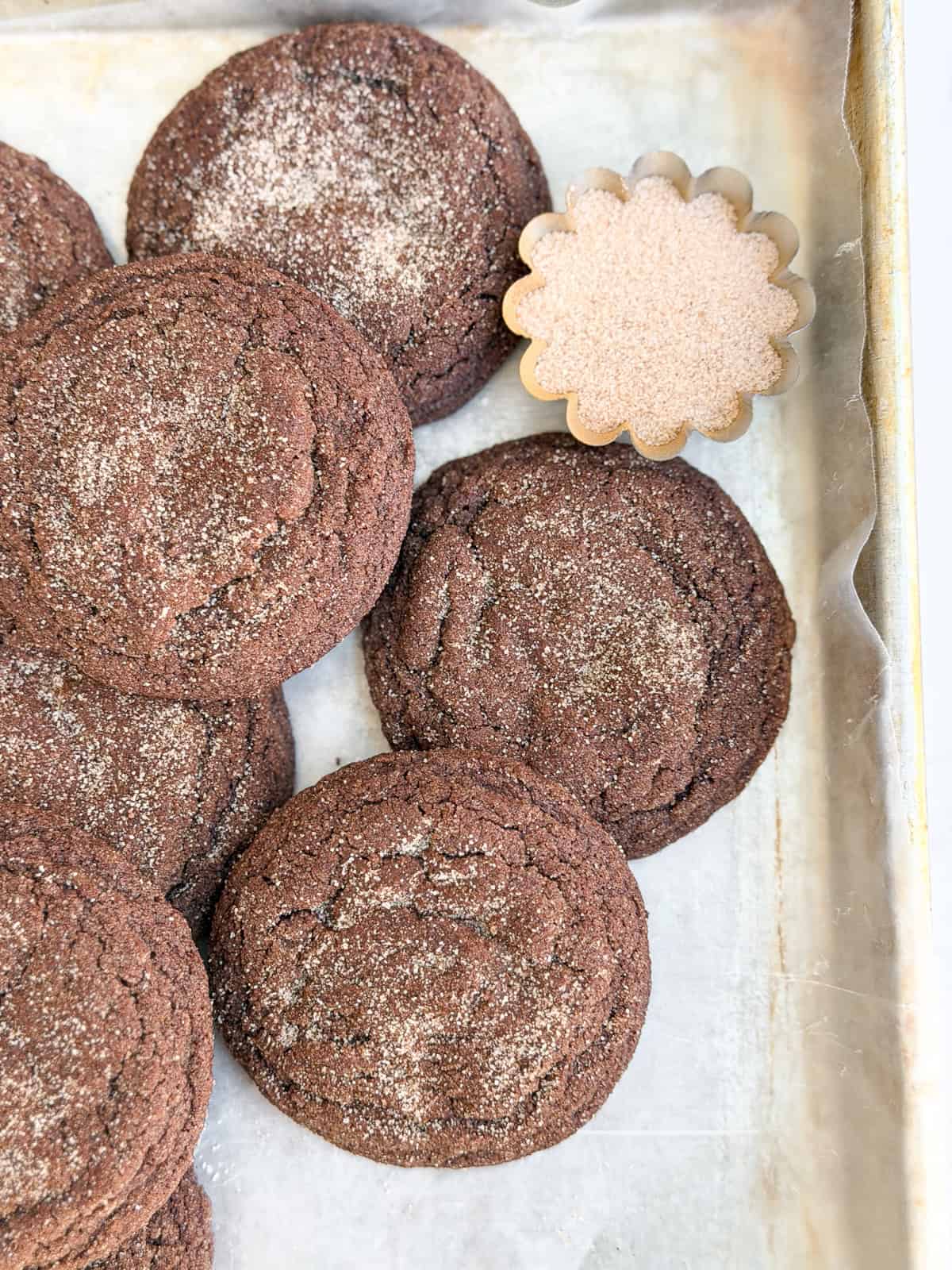 a few chocolate snickerdoodle cookies stacked together.