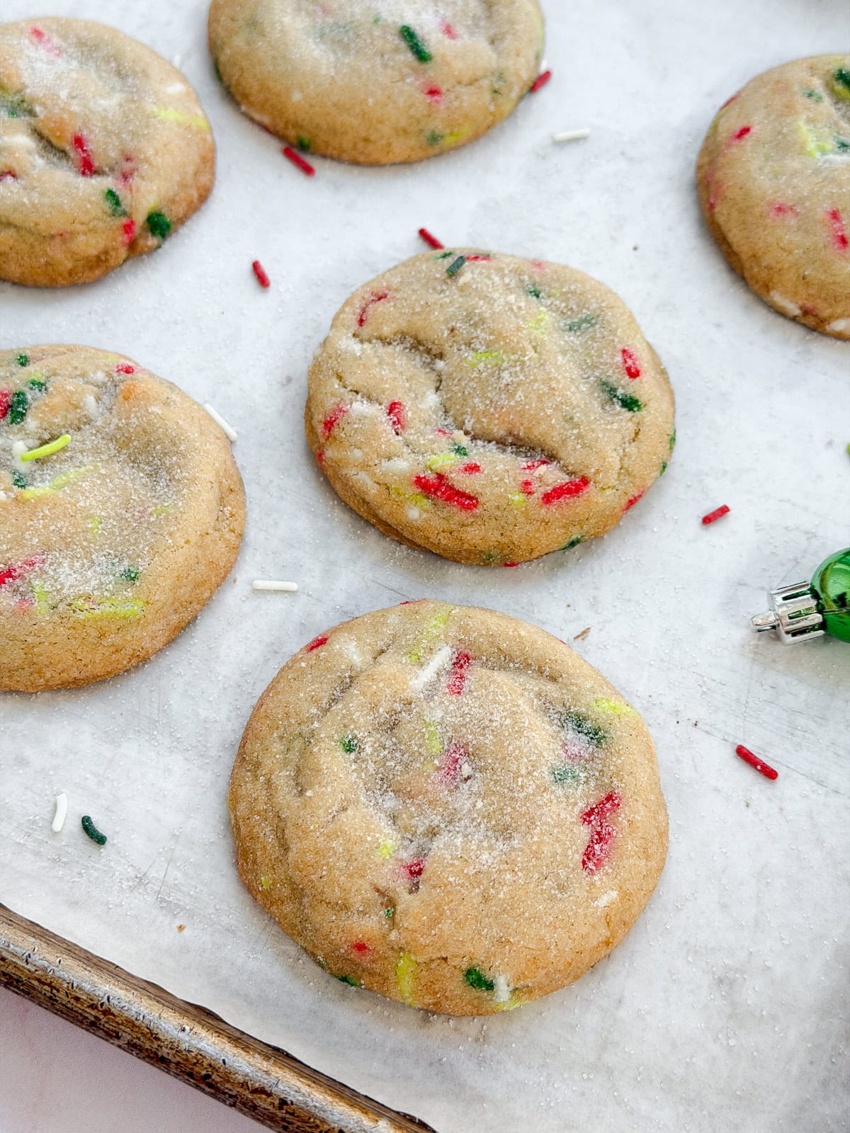 a side view of a few cookies on a baking sheet.