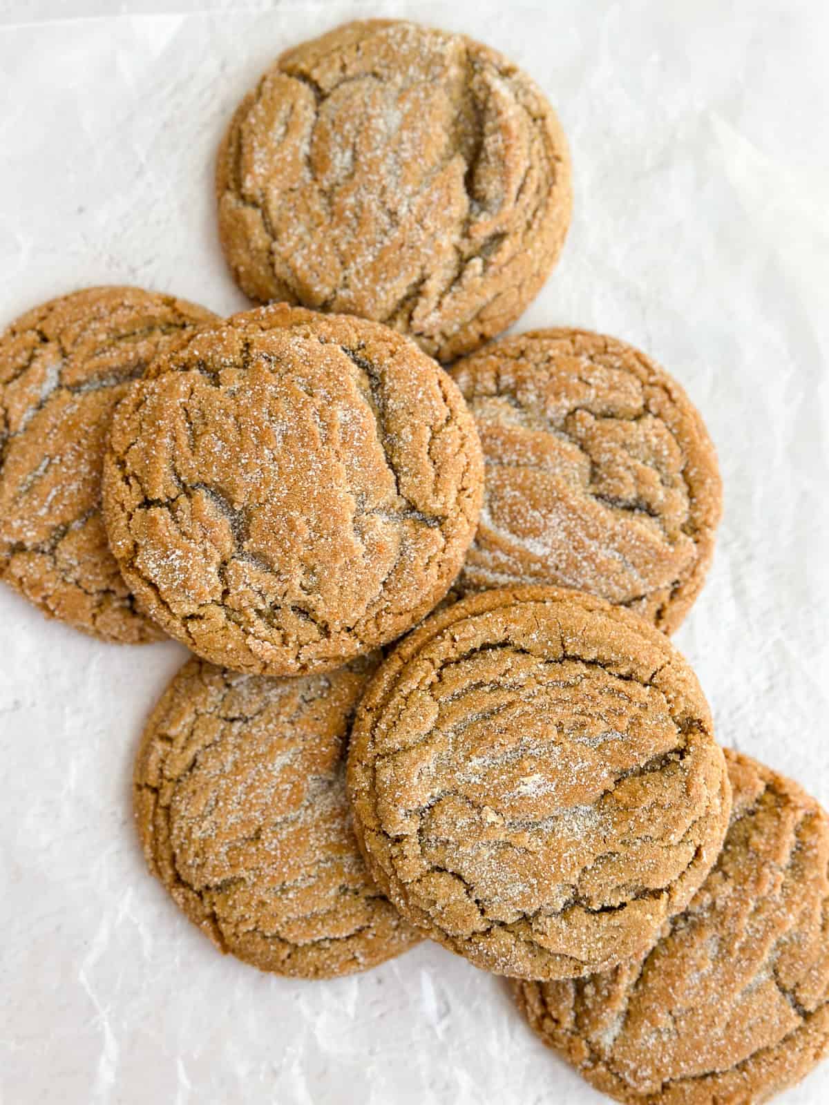 a bunch of chewy ginger molasses cookies stacked together.