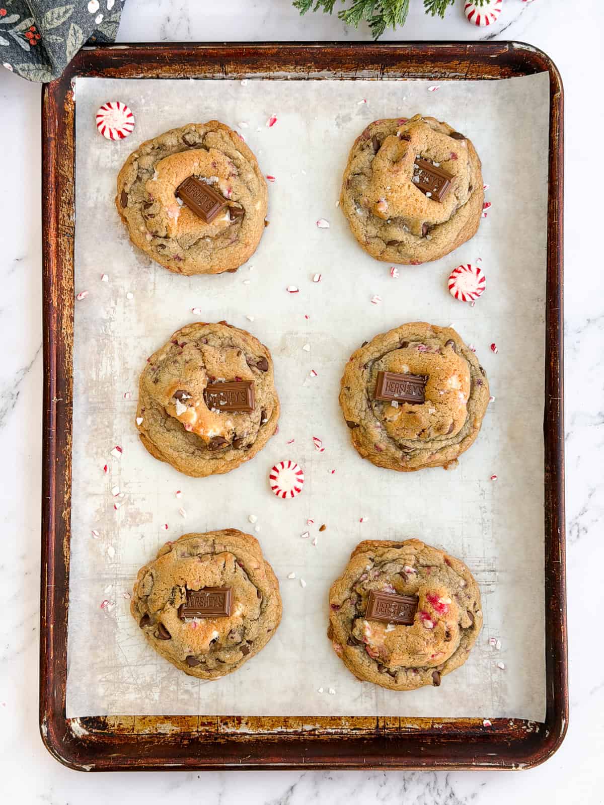 6 chocolate peppermint s'mores cookies on a baking sheet.