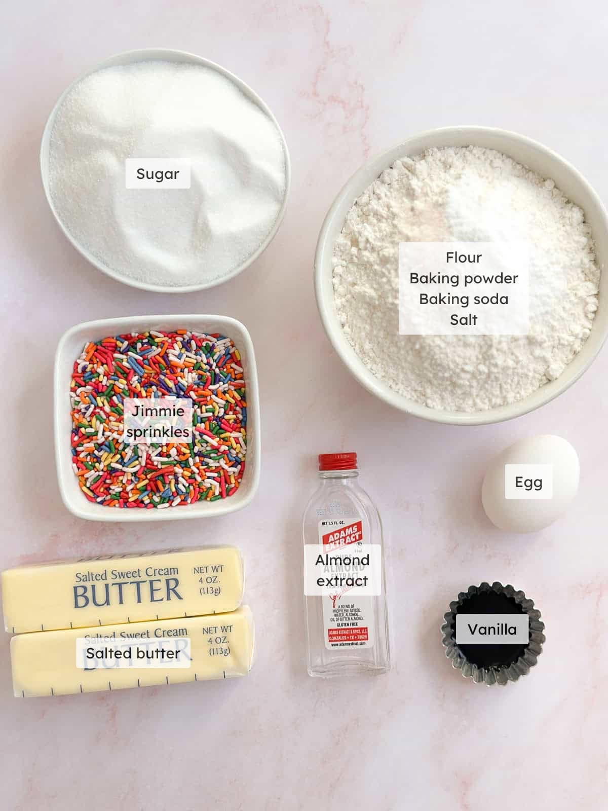 All of the ingredients needed to make sprinkle sugar cookies.