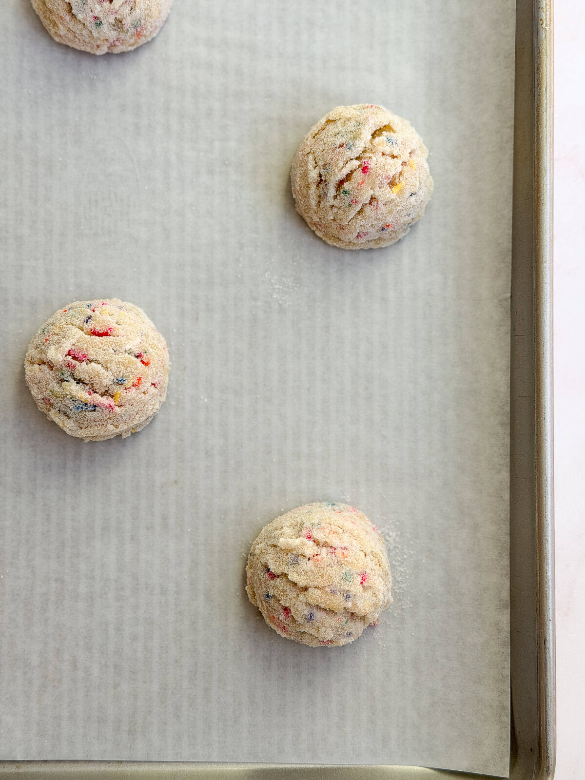 cookie dough balls on the baking sheet before baking.