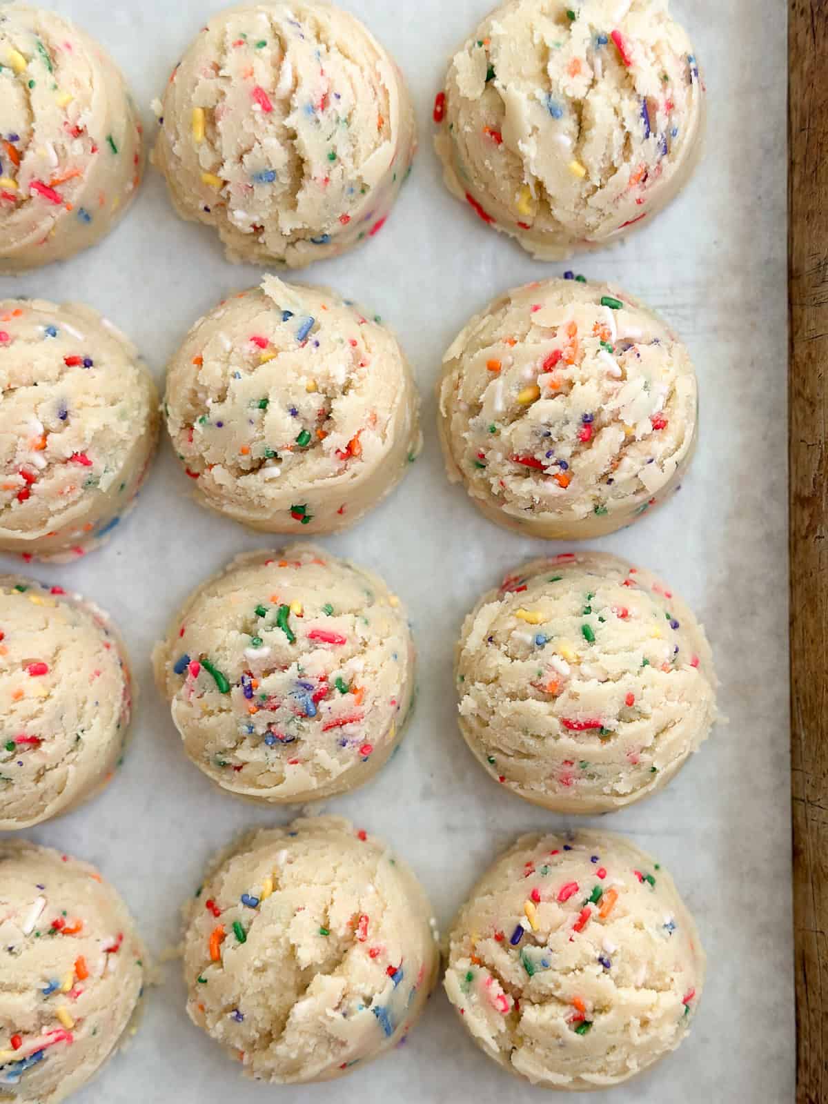 a bunch of cookie dough balls in a row.