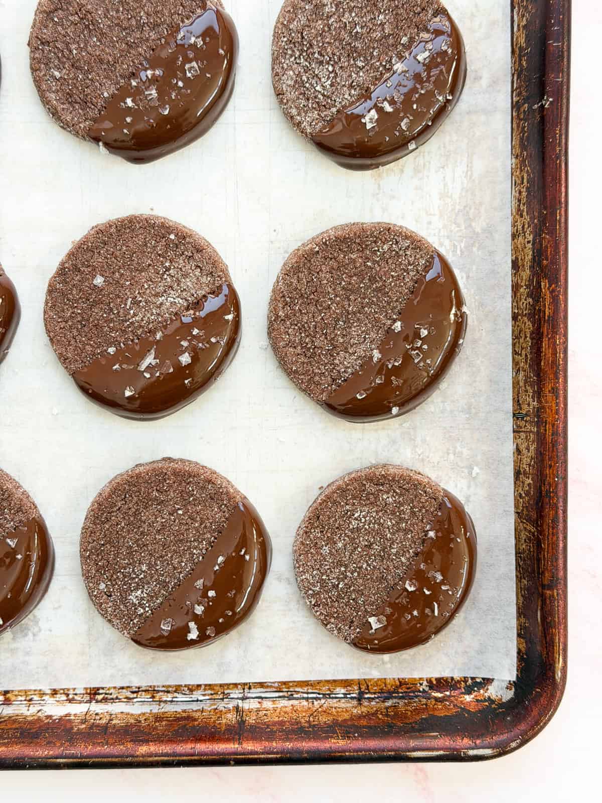 cookies after dipping in melted chocolate and sprinkling with flaked salt.